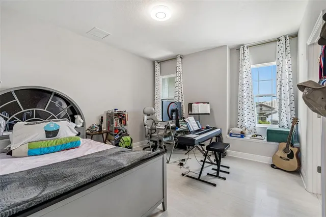 a bedroom with a large bed and a window