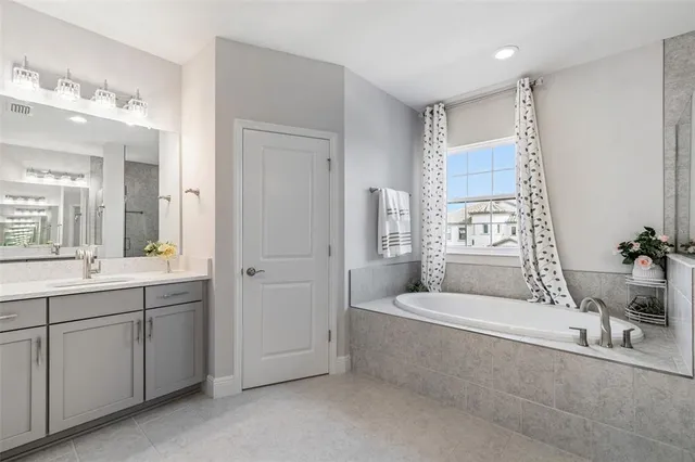 a bathroom with a sink double vanity granite and a mirror