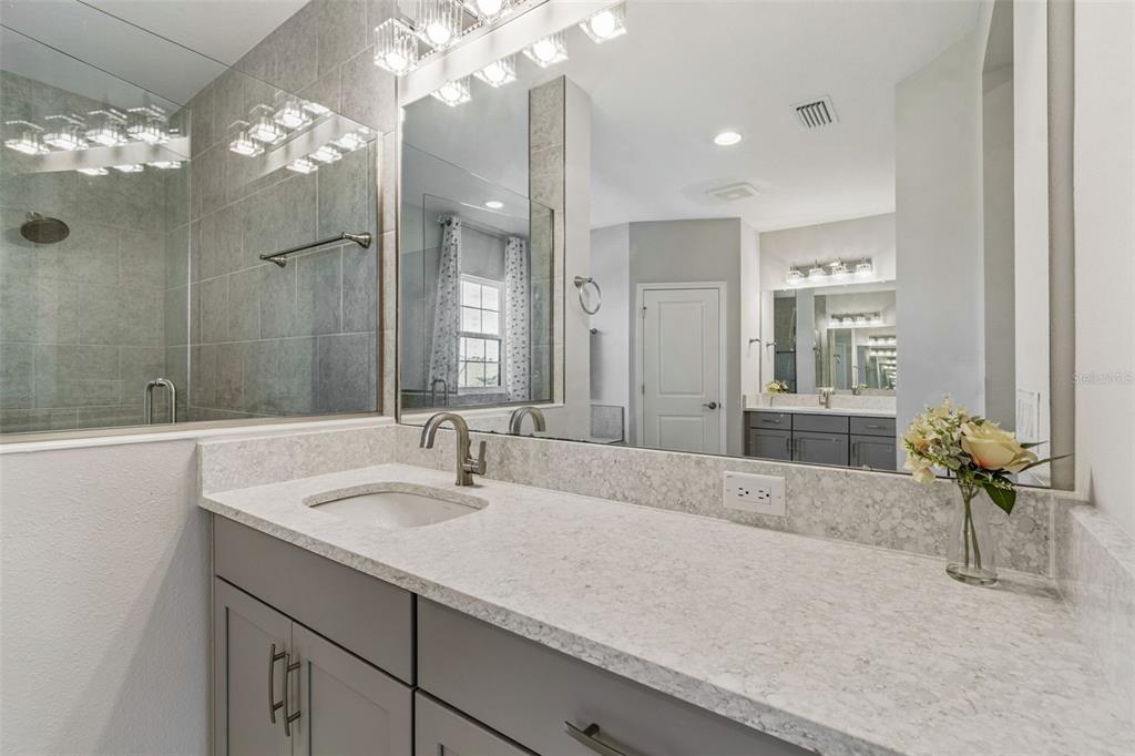 10863 Rustic Timber Loop San Antonio, FL 33576 - Photo 41 of 56 a bathroom with a sink double vanity granite and a mirror