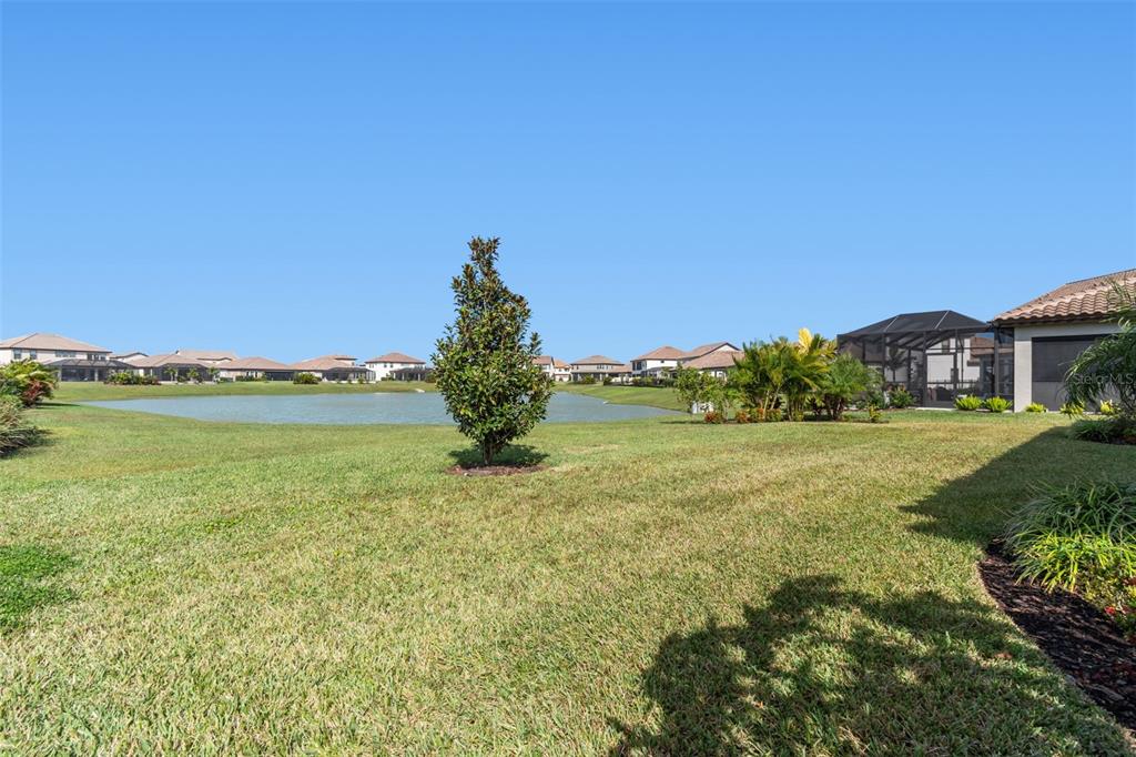 10863 Rustic Timber Loop San Antonio, FL 33576 - Photo 46 of 56 a view of a house with a garden and lake view