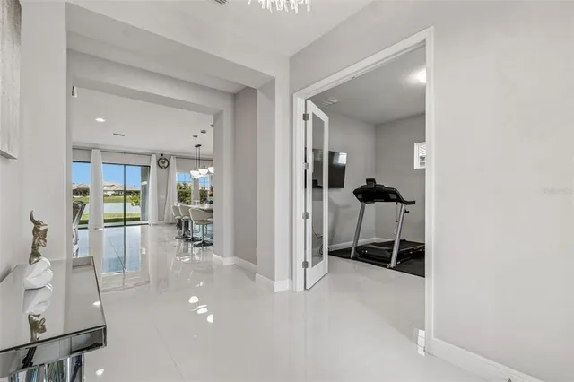 a kitchen with granite countertop a sink a stove cabinets and living room view