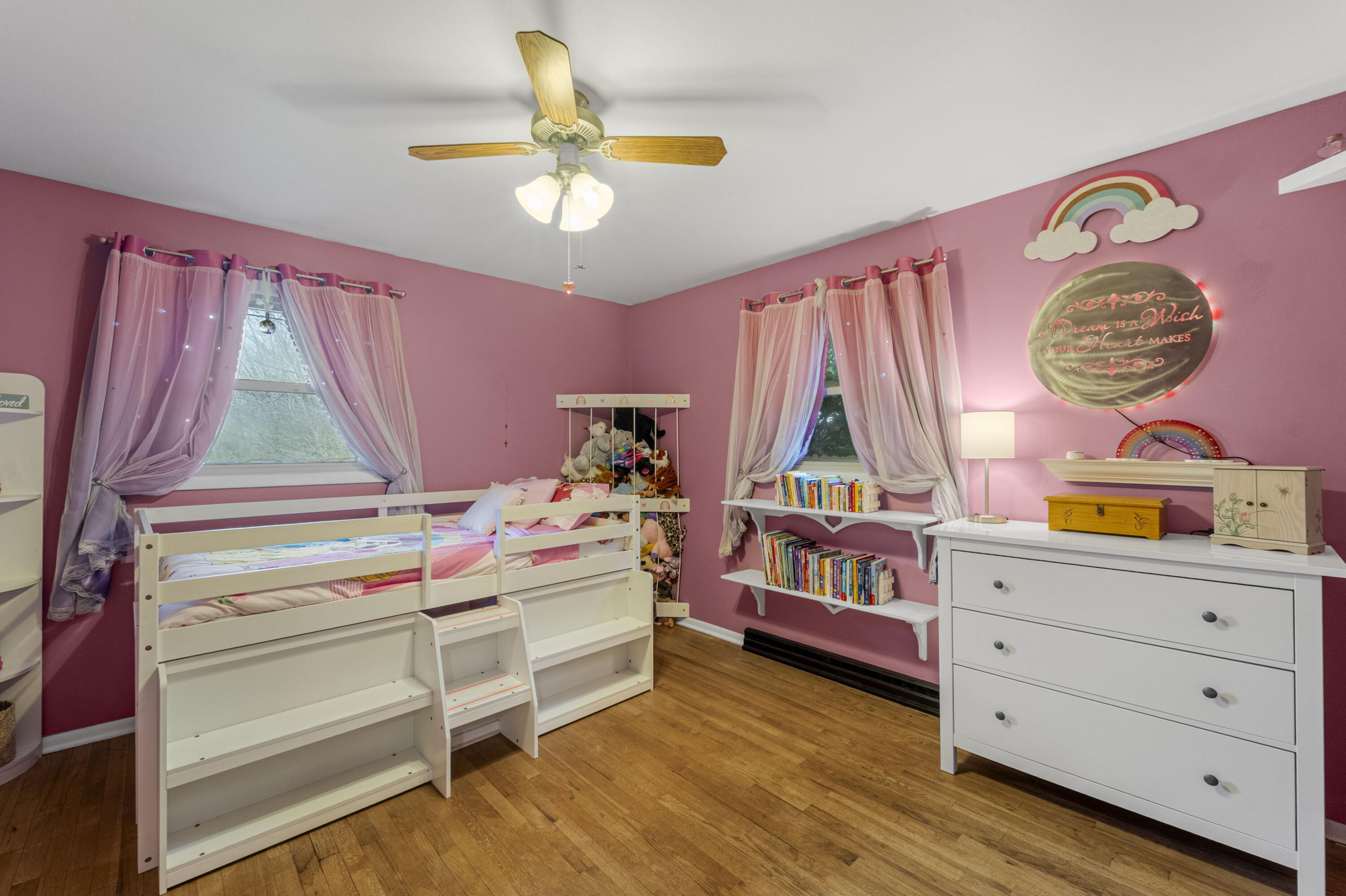 827 South Fancher Road Mount Pleasant, WI 53406 - Photo 14 of 26 Bright bedroom with hardwood flooring, two windows, and cheerful color throughout.