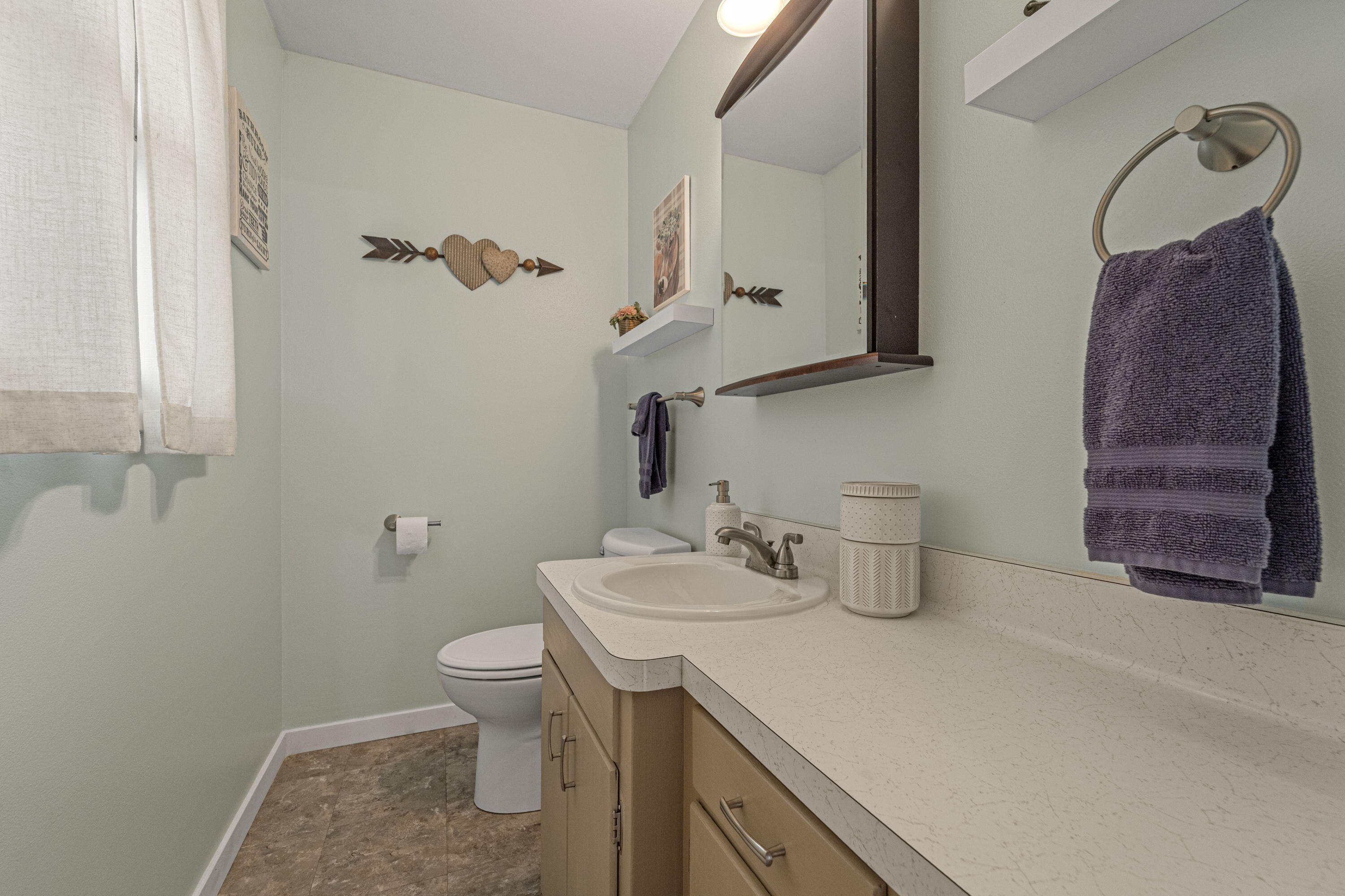 827 South Fancher Road Mount Pleasant, WI 53406 - Photo 16 of 26 Convenient half bath with updated vanity, neutral finishes, and natural light.