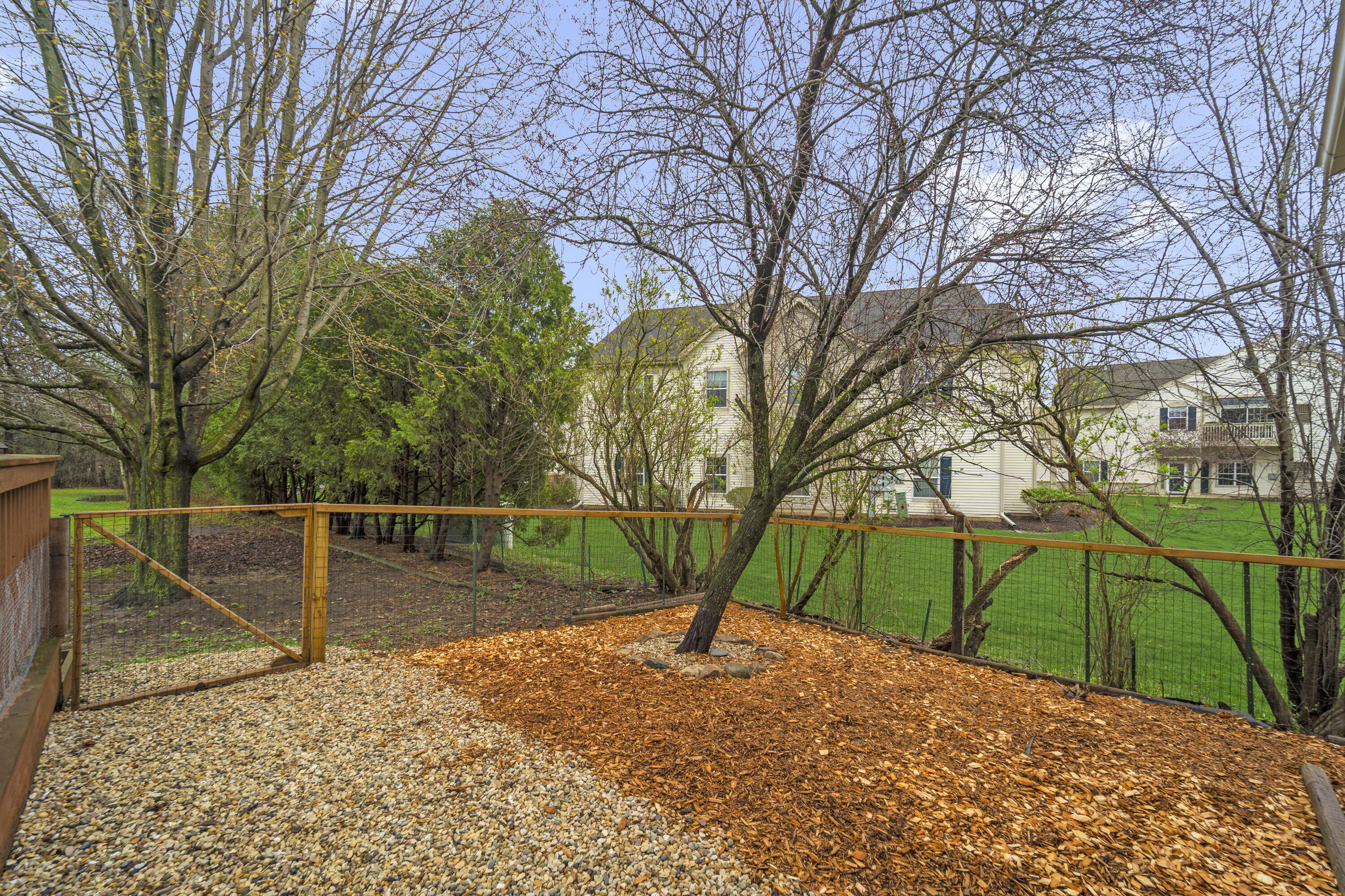 827 South Fancher Road Mount Pleasant, WI 53406 - Photo 24 of 26 Partially fenced section with mature trees, ideal for pets, gardening, or outdoor space.