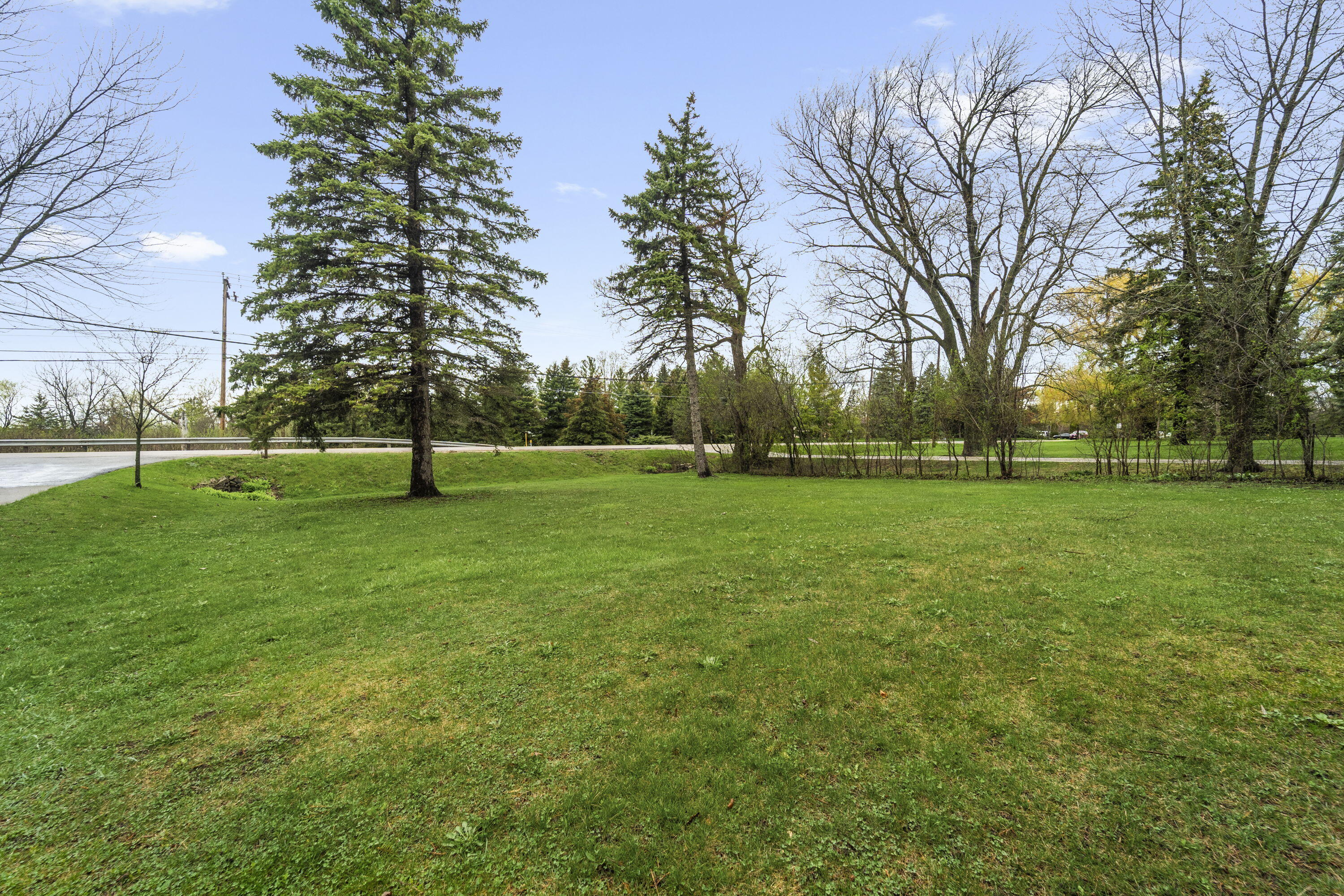 827 South Fancher Road Mount Pleasant, WI 53406 - Photo 26 of 26 Expansive yard with mature trees and open green space, ideal for recreation or outdoor use.