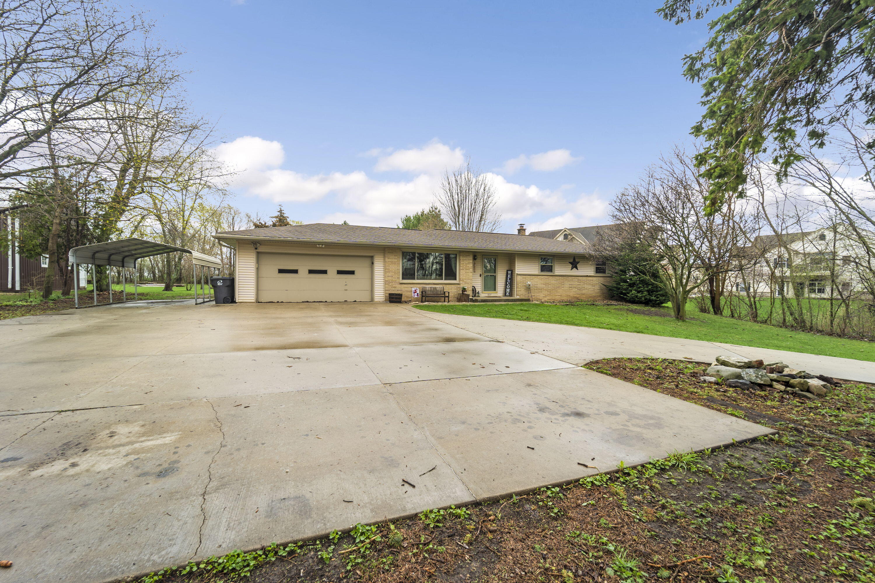 827 South Fancher Road Mount Pleasant, WI 53406 - Photo 3 of 26 Large concrete driveway with ample parking plus covered side space for added convenience.