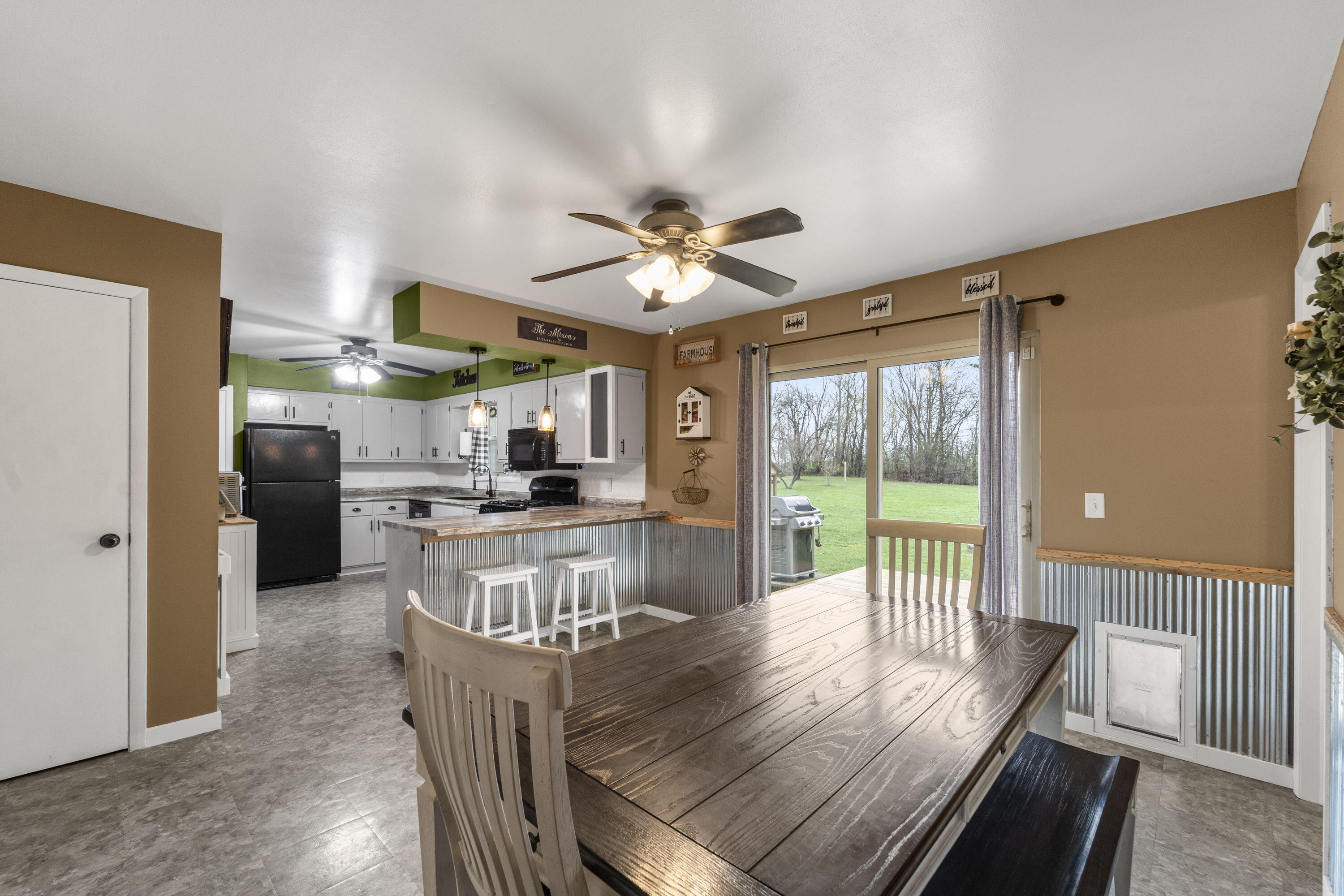 827 South Fancher Road Mount Pleasant, WI 53406 - Photo 7 of 26 Open dining area flows into kitchen with breakfast bar and sliding doors to backyard deck.
