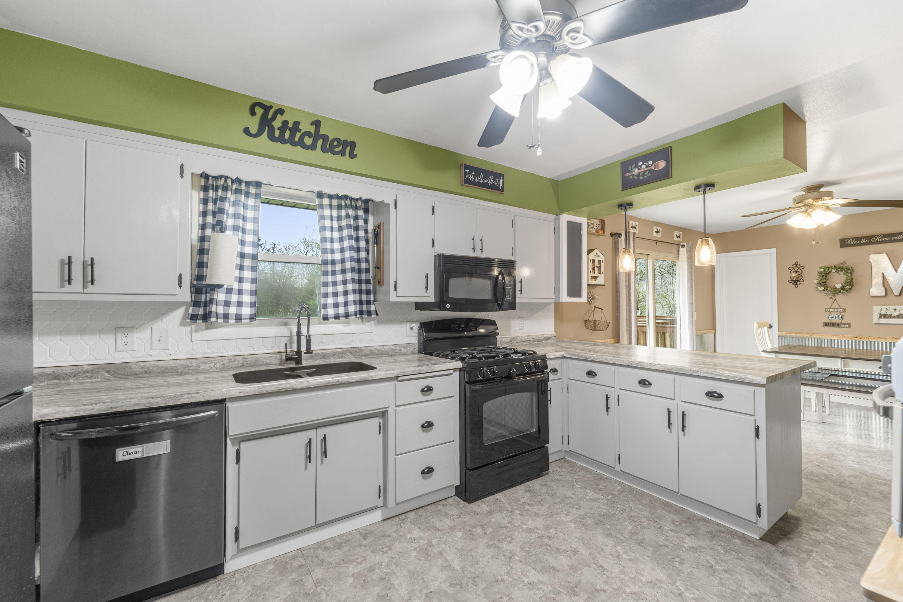 827 South Fancher Road Mount Pleasant, WI 53406 - Photo 8 of 26 Kitchen features white cabinetry, gas range, and stylish finishes with great workflow.