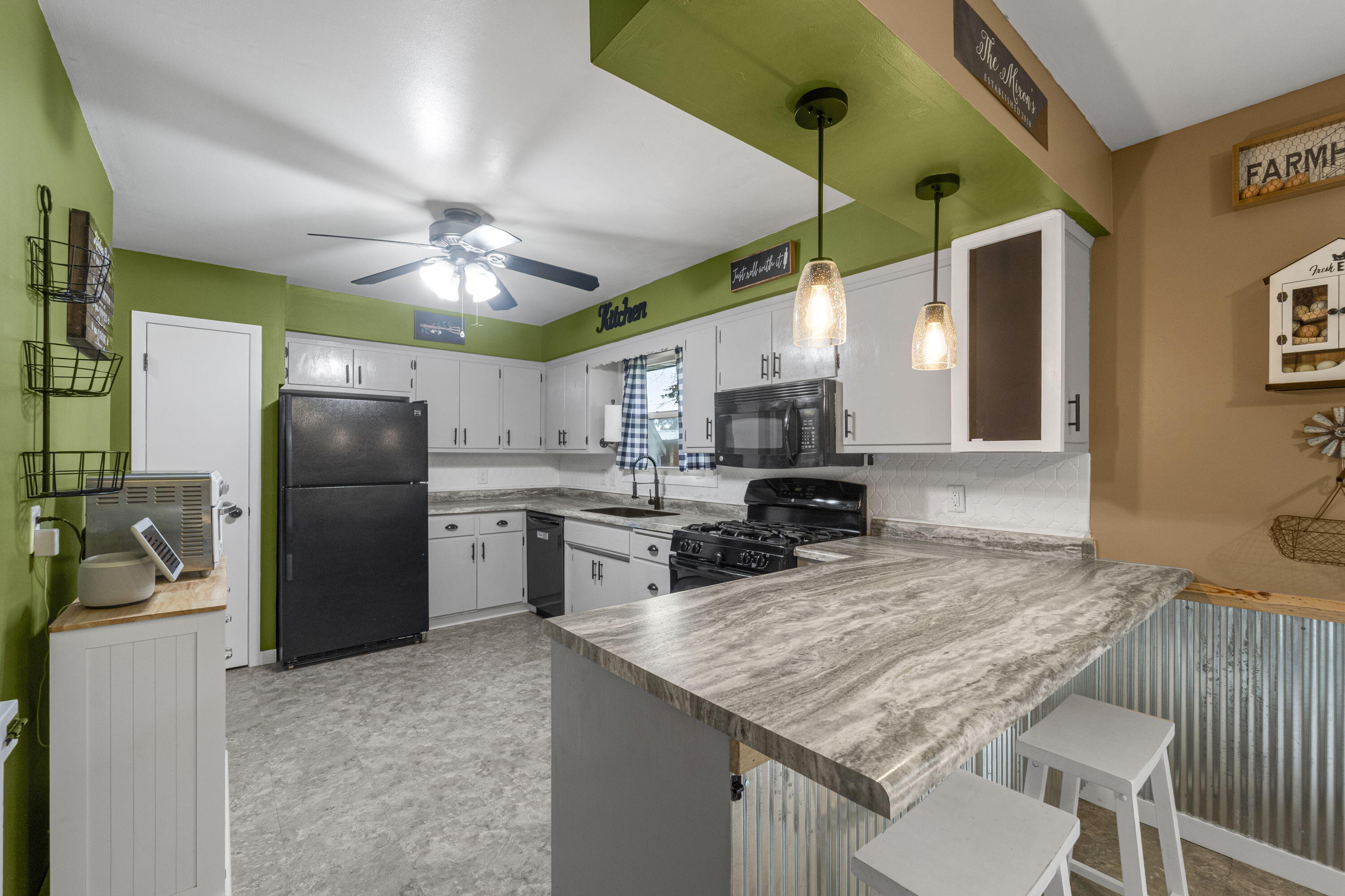 827 South Fancher Road Mount Pleasant, WI 53406 - Photo 9 of 26 Functional kitchen with peninsula seating, ample cabinetry, and open layout to dining.