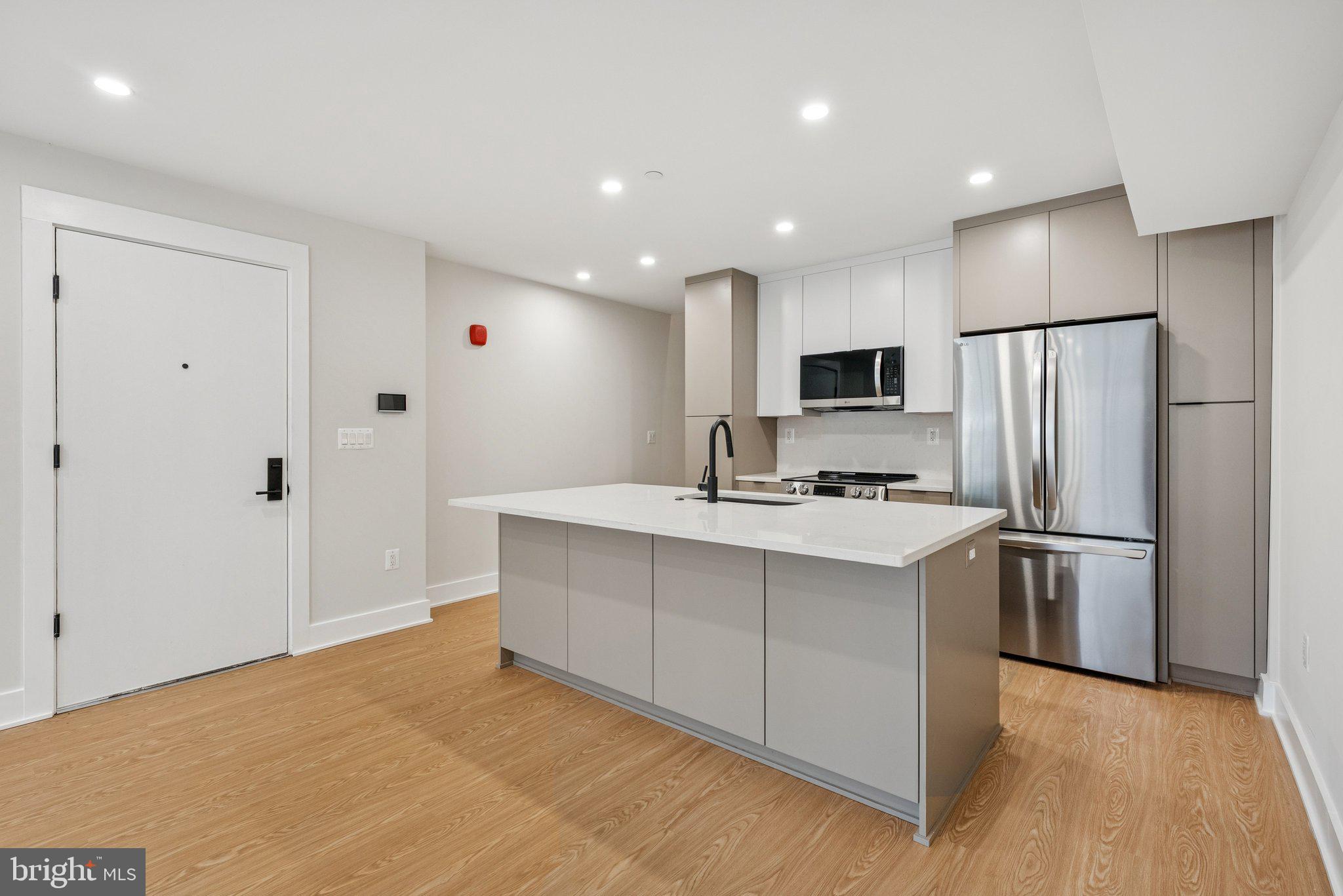 2134 Wisconsin Avenue Northwest, Unit 4 Washington, DC 20007 - Photo 1 of 32 a kitchen with stainless steel appliances a refrigerator stove microwave and sink