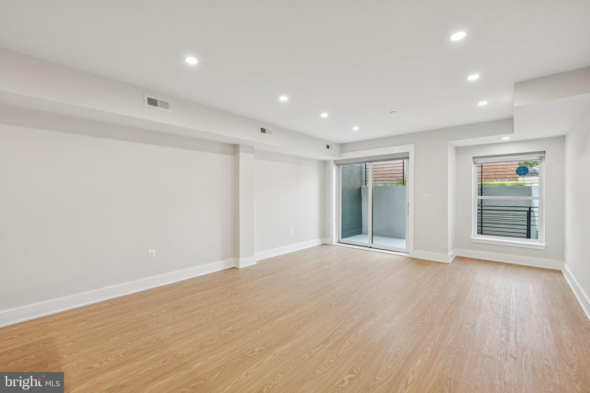 2134 Wisconsin Avenue Northwest, Unit 4 Washington, DC 20007 - Photo 11 of 32 a view of an empty room with wooden floor and windows