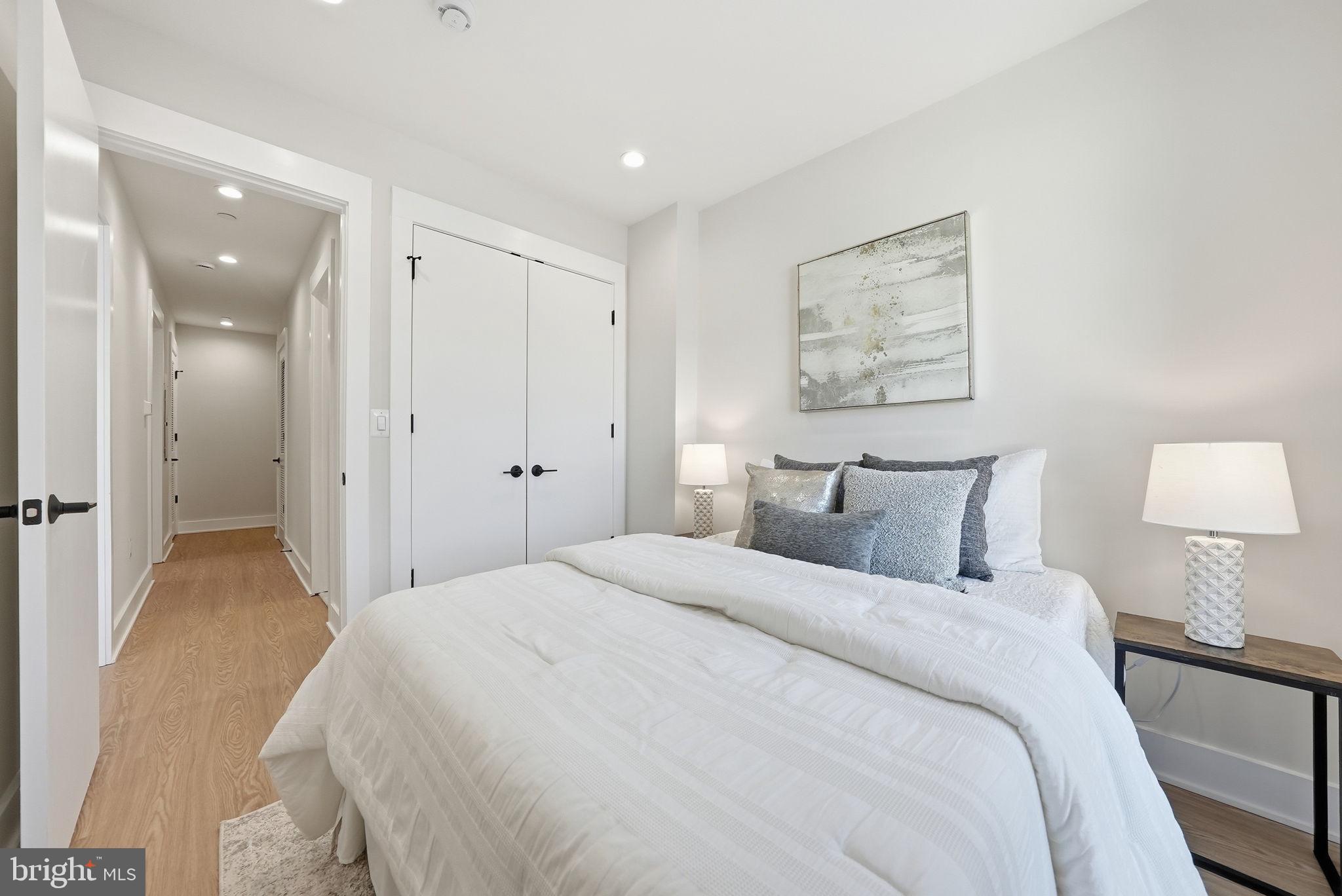 2134 Wisconsin Avenue Northwest, Unit 4 Washington, DC 20007 - Photo 13 of 35 a spacious bedroom with a bed and a lamp