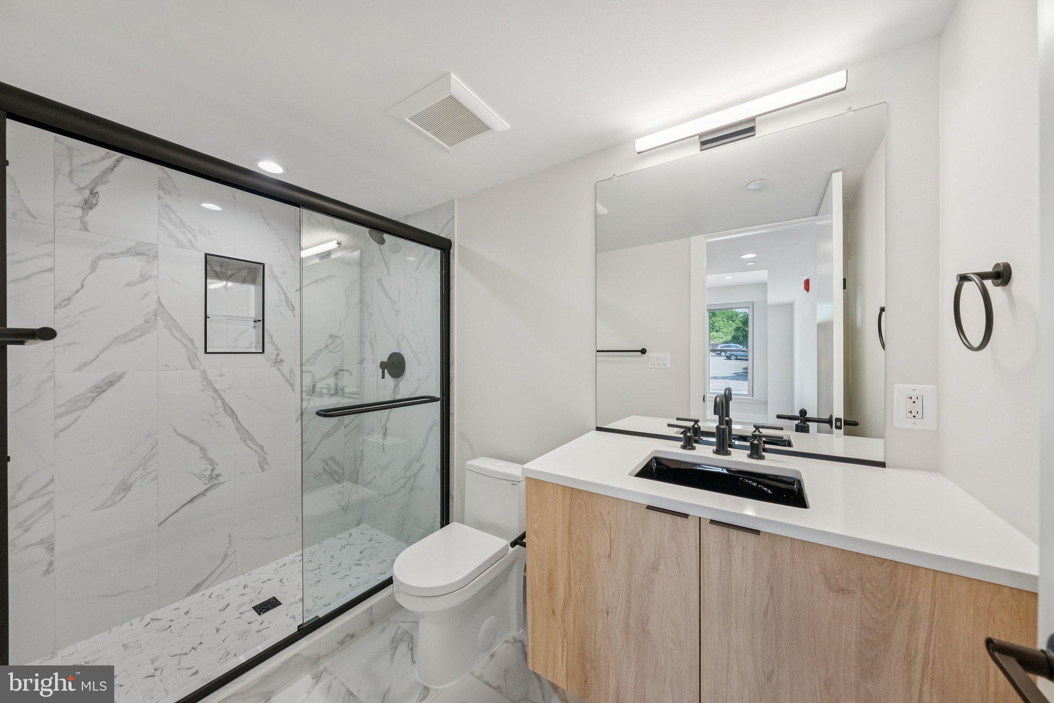 2134 Wisconsin Avenue Northwest, Unit 4 Washington, DC 20007 - Photo 15 of 32 a bathroom with a sink a toilet and shower
