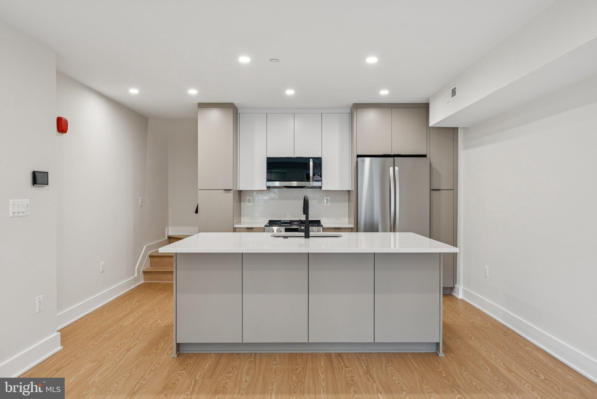 2134 Wisconsin Avenue Northwest, Unit 4 Washington, DC 20007 - Photo 2 of 32 a view of kitchen with stainless steel appliances granite countertop a sink a stove a refrigerator a center island and a window