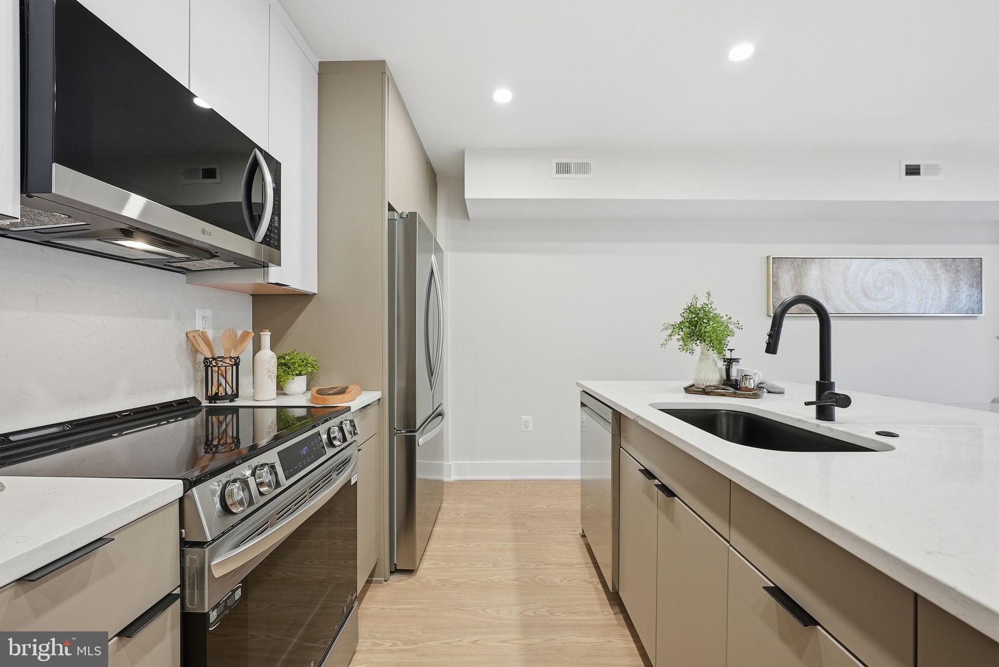 2134 Wisconsin Avenue Northwest, Unit 4 Washington, DC 20007 - Photo 8 of 35 a kitchen that has a sink and a stove in it