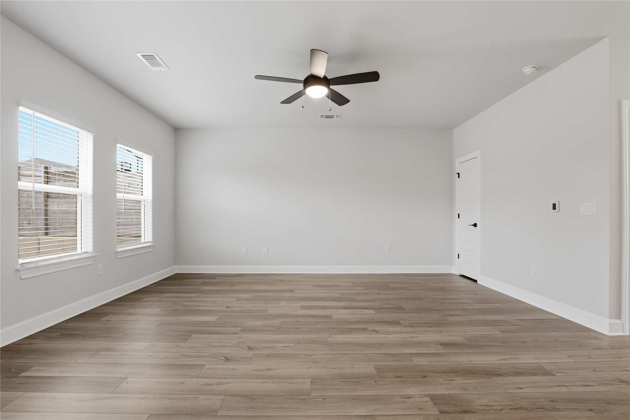 9320 Gladsome Path Manor, TX 78653 - Photo 11 of 34 wooden floor in an empty room with a window