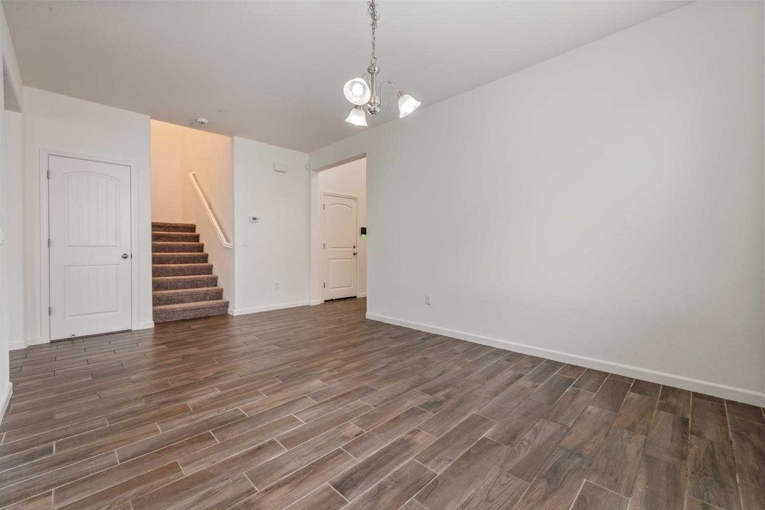 1513 Rock Spring Avenue Manteca, CA 95337 - Photo 13 of 56 a view of a room with wooden floor and staircase