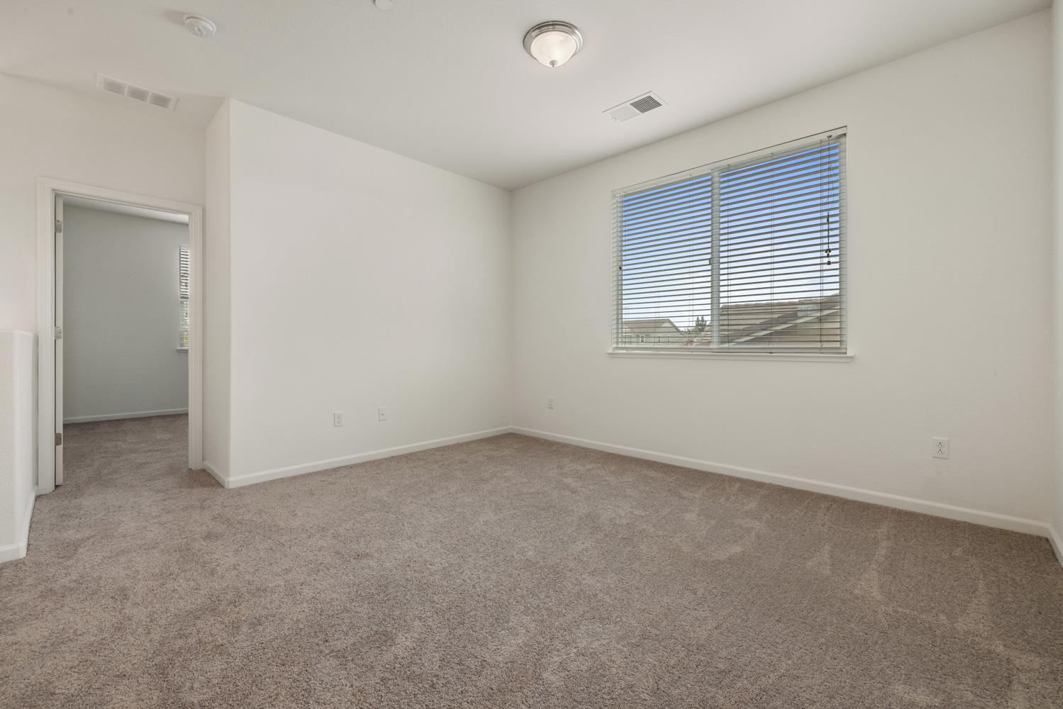 1513 Rock Spring Avenue Manteca, CA 95337 - Photo 23 of 56 an empty room with a window