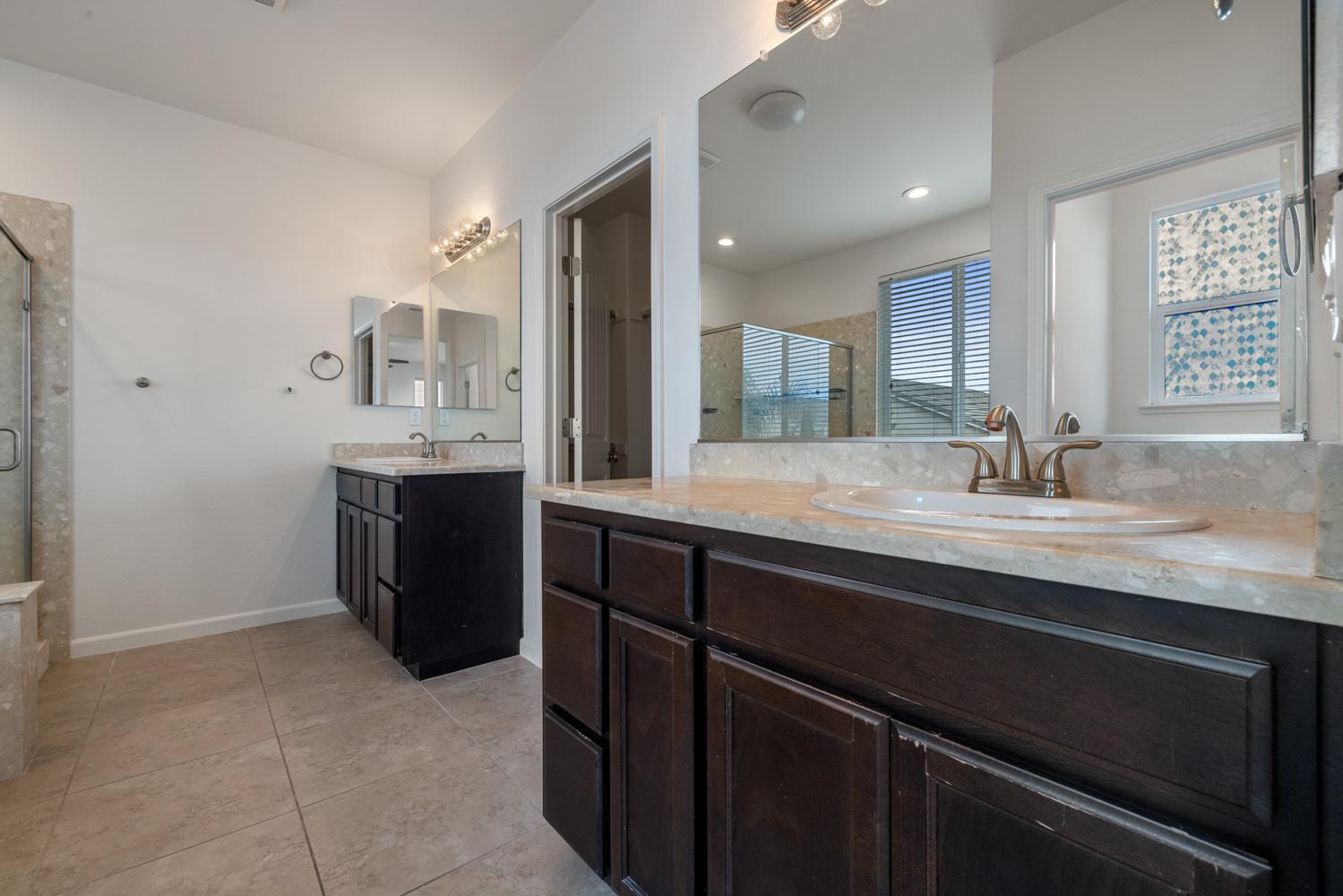 1513 Rock Spring Avenue Manteca, CA 95337 - Photo 30 of 56 a bathroom with a sink and a mirror