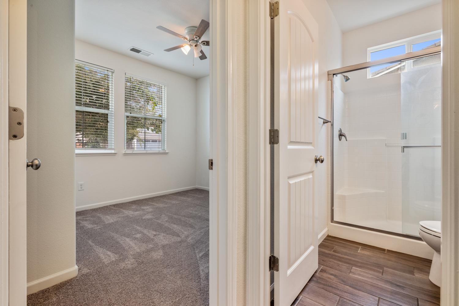 1513 Rock Spring Avenue Manteca, CA 95337 - Photo 8 of 56 a view of an empty room with wooden floor and a window