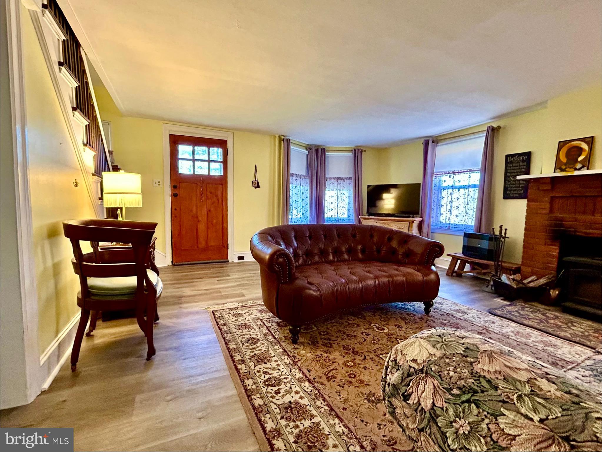 2415 Second Street Pike Newtown, PA 18940 - Photo 7 of 51 a living room with furniture a dining table and a piano next to a window