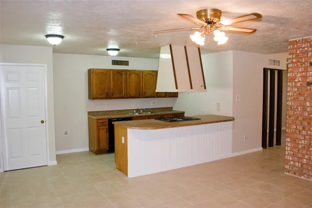 a view of kitchen with granite countertop cabinets and a stove