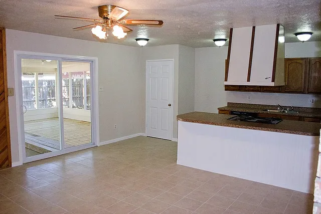 a view of a livingroom with a chandelier fan