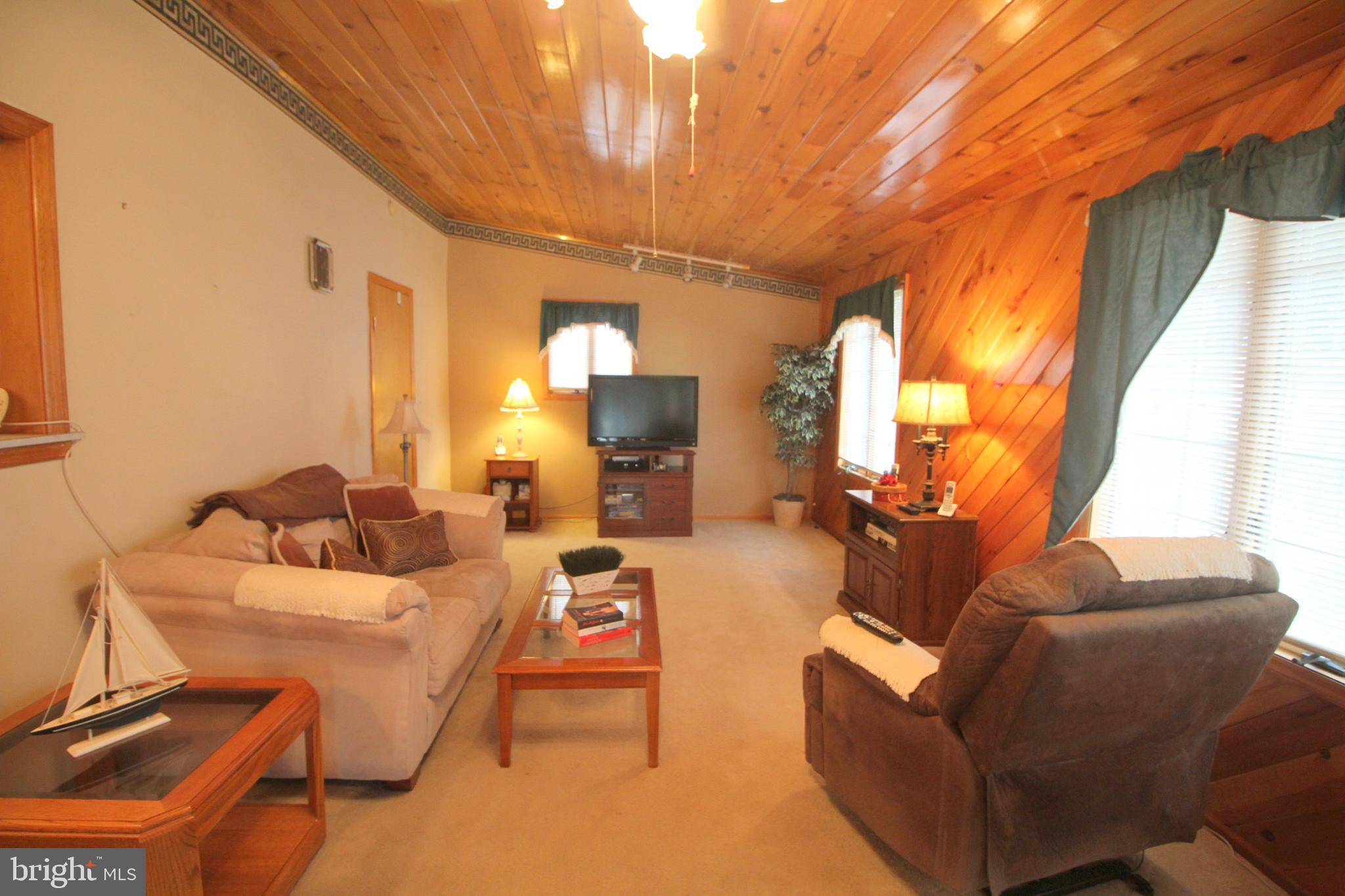 6 Claude Road Hamilton, NJ 08620 - Photo 12 of 29 a living room with furniture a large window and a chandelier