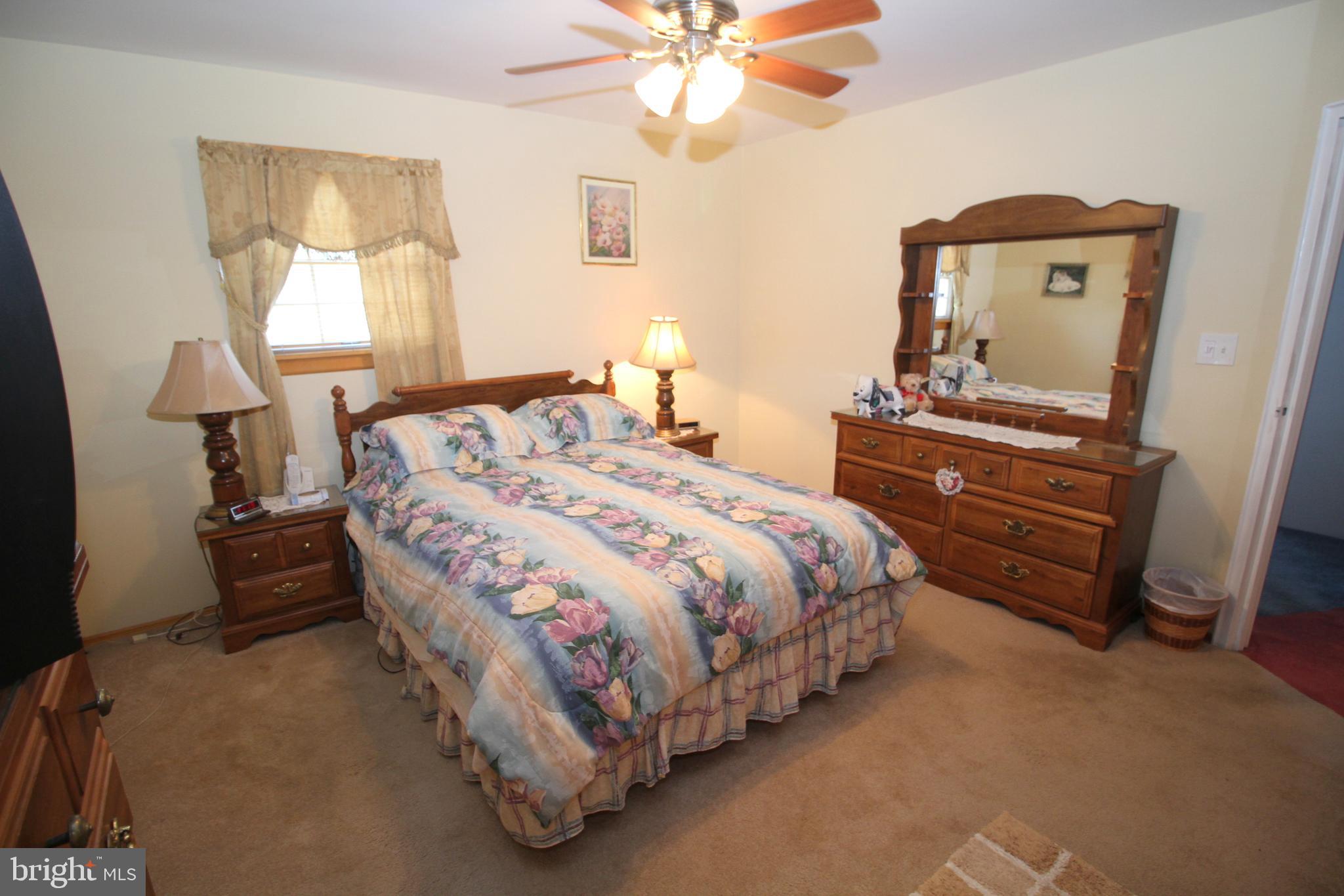 6 Claude Road Hamilton, NJ 08620 - Photo 16 of 29 a bedroom with a bed and a chandelier