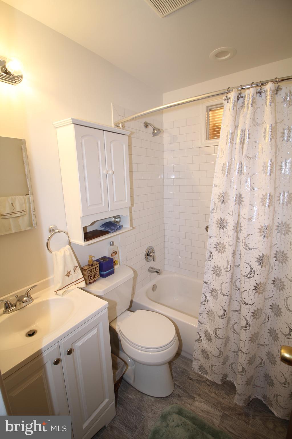 6 Claude Road Hamilton, NJ 08620 - Photo 19 of 29 a bathroom with a sink a toilet and shower curtain