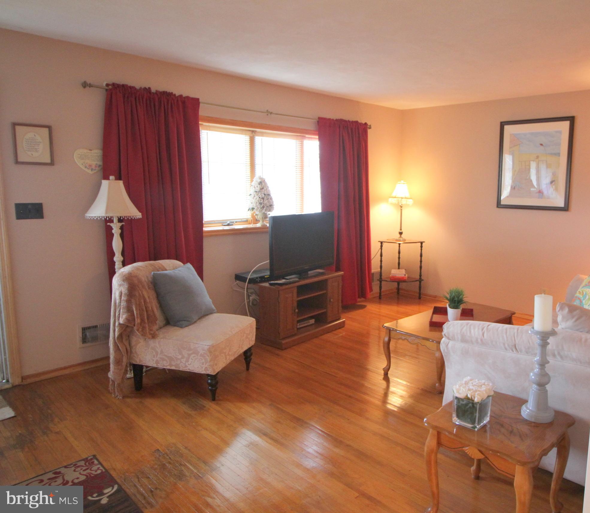 6 Claude Road Hamilton, NJ 08620 - Photo 7 of 29 a living room with furniture a lamp and a window