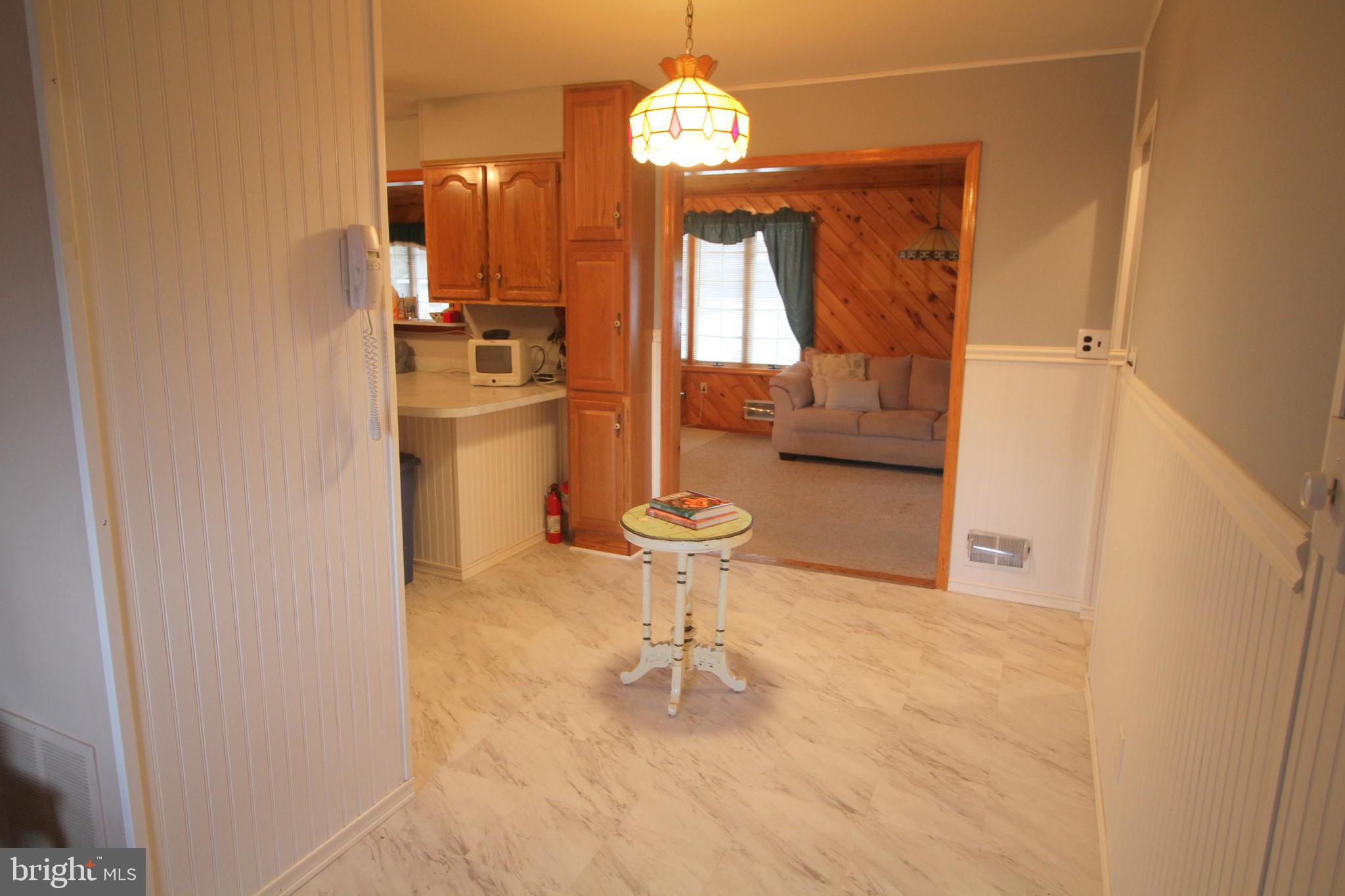 6 Claude Road Hamilton, NJ 08620 - Photo 8 of 29 a dining room with a sink and a chandelier