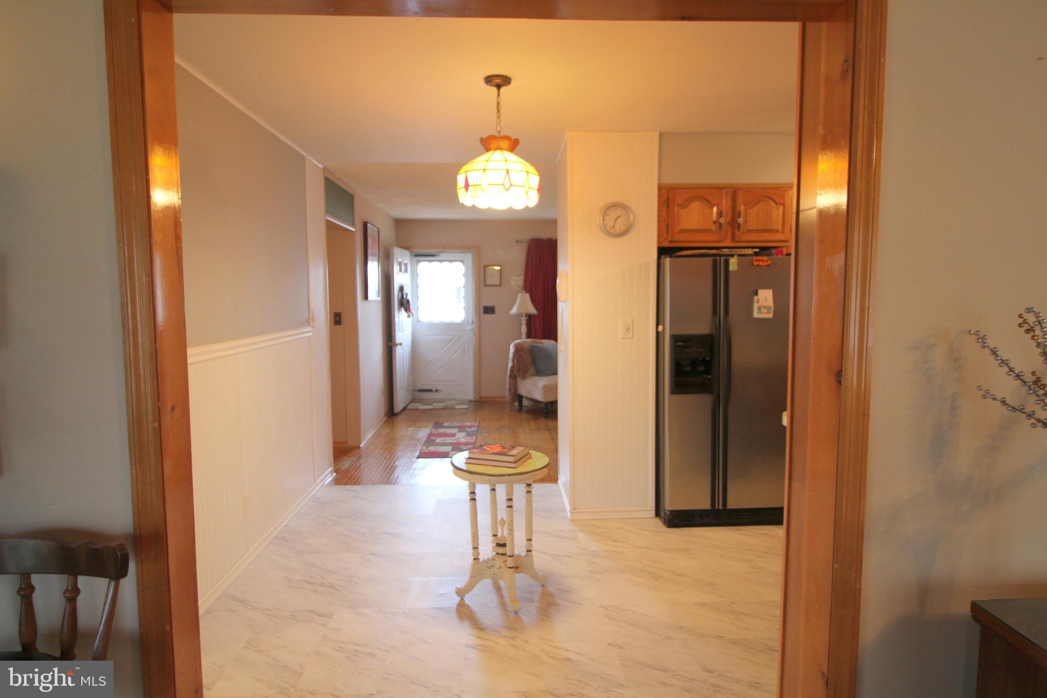 6 Claude Road Hamilton, NJ 08620 - Photo 9 of 29 a view of a hallway that has a dining table and chandelier