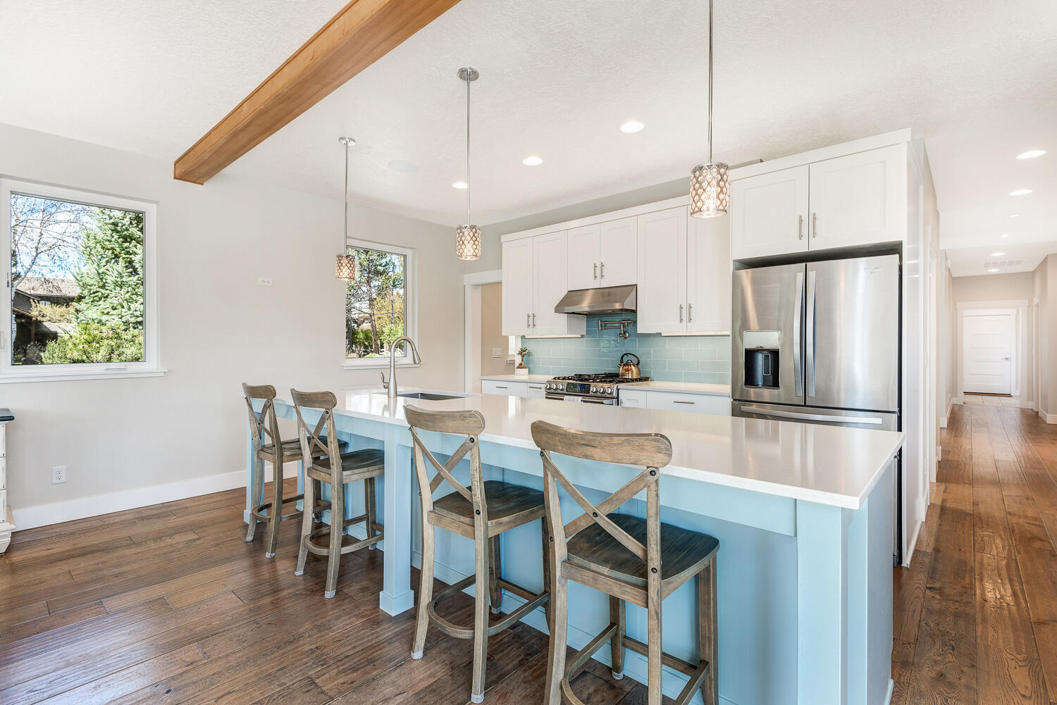61510 Southwest Longview Street Bend, OR 97702 - Photo 20 of 43 a kitchen with stainless steel appliances a dining table chairs refrigerator and microwave