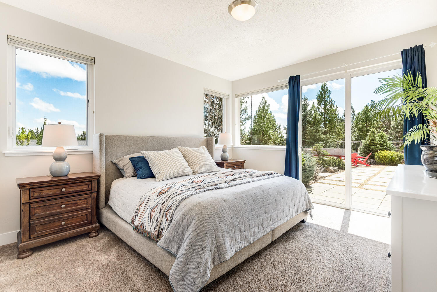 61510 Southwest Longview Street Bend, OR 97702 - Photo 26 of 43 a bedroom with a large bed and a flat tv screen next to a window
