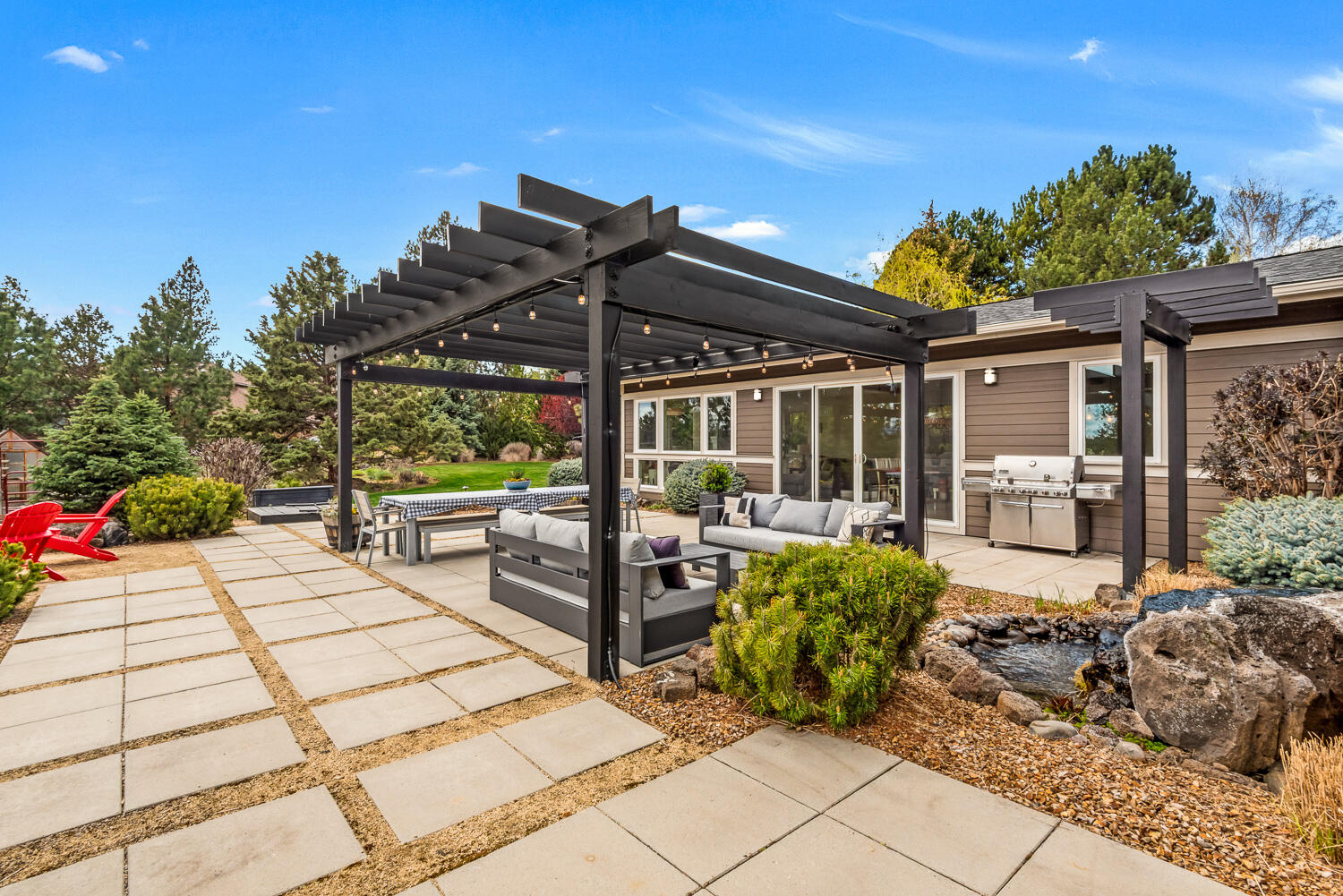 61510 Southwest Longview Street Bend, OR 97702 - Photo 10 of 43 a view of a patio with table and chairs potted plants with wooden floor