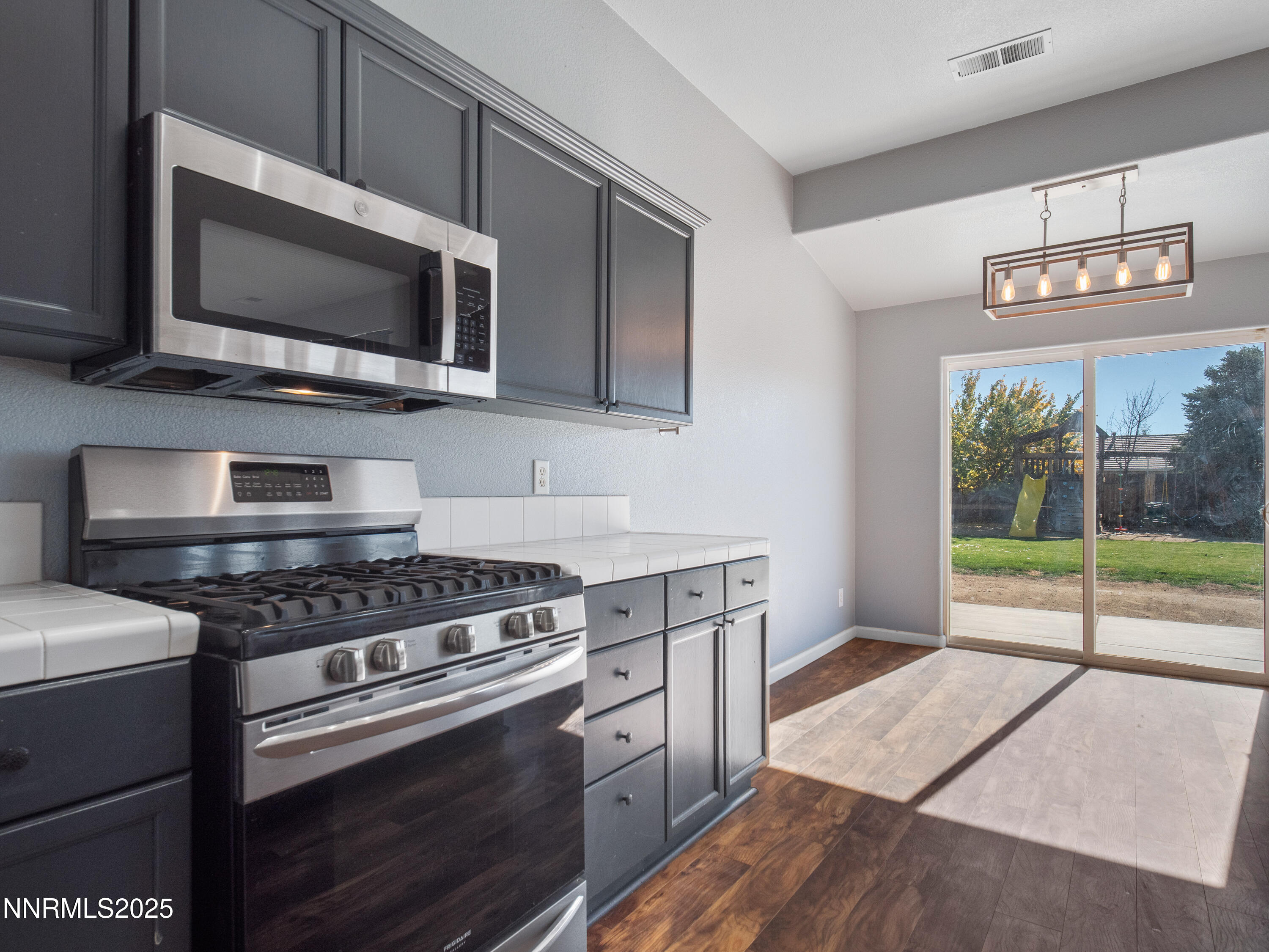 117 Elk Horn Drive Dayton, NV 89403 - Photo 14 of 59 a kitchen with a stove and a microwave