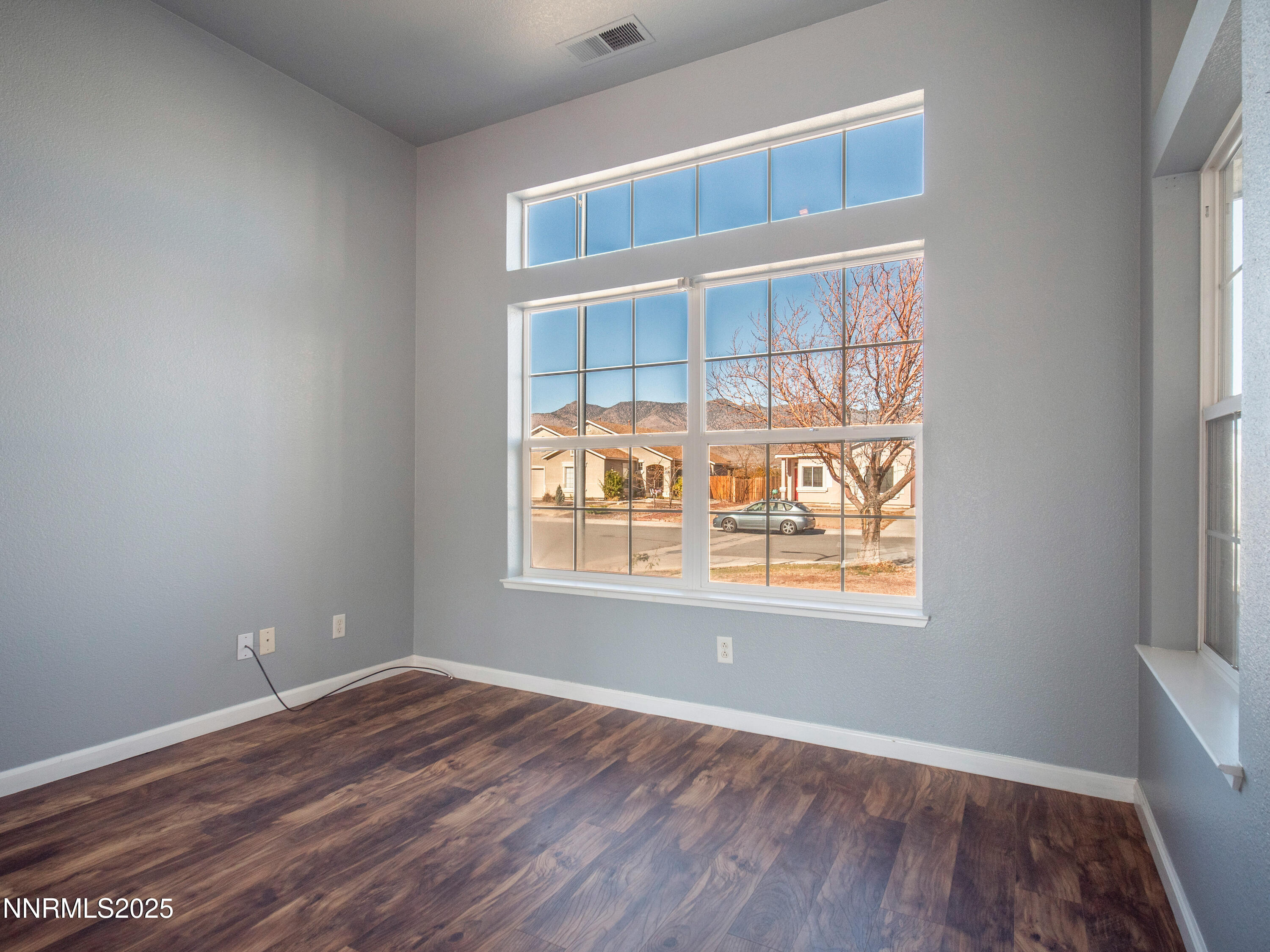 117 Elk Horn Drive Dayton, NV 89403 - Photo 29 of 59 an empty room with wooden floor and windows
