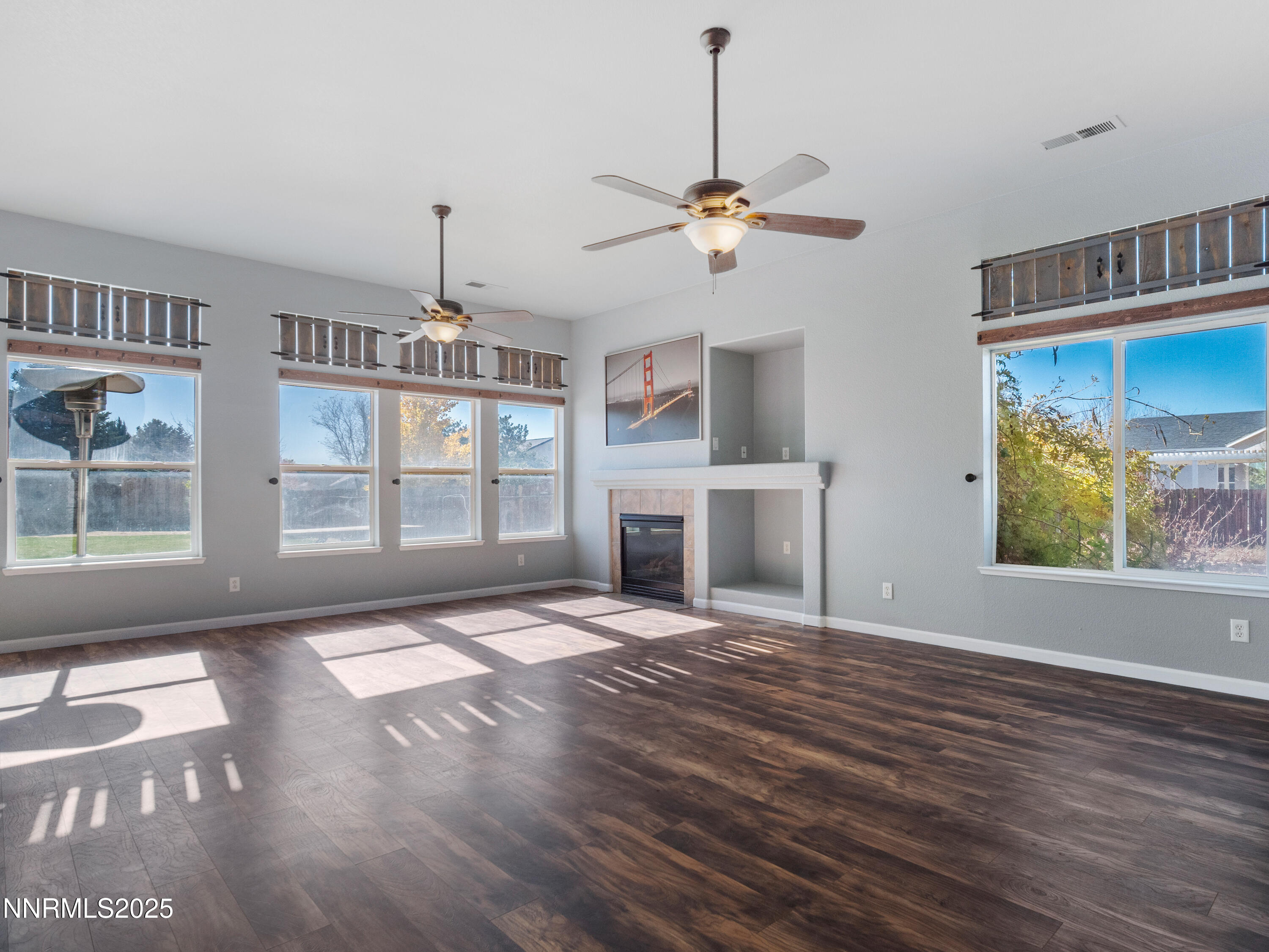 117 Elk Horn Drive Dayton, NV 89403 - Photo 6 of 59 a view of an empty room with window and wooden floor