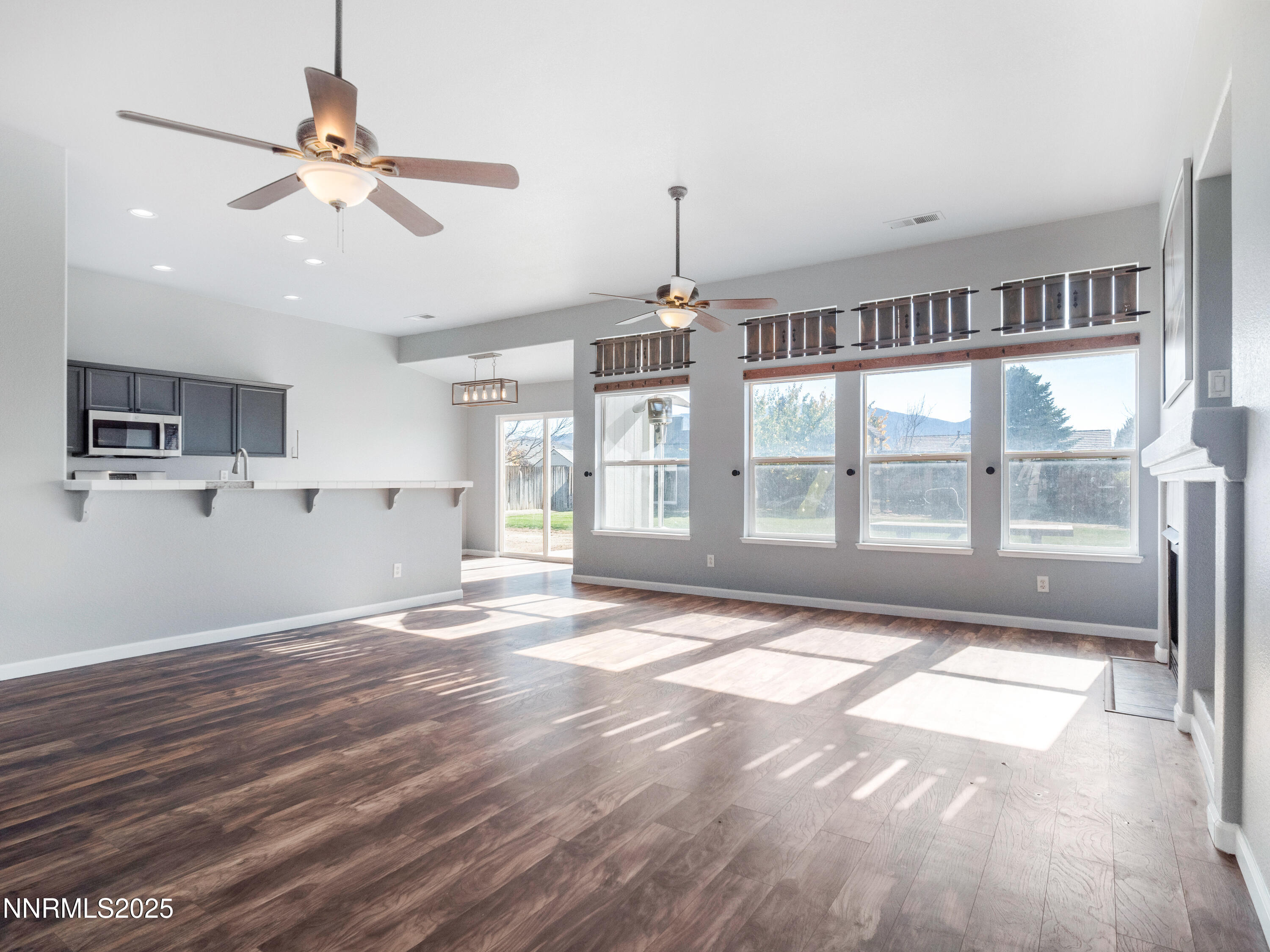 117 Elk Horn Drive Dayton, NV 89403 - Photo 7 of 59 a view of an empty room with window and wooden floor