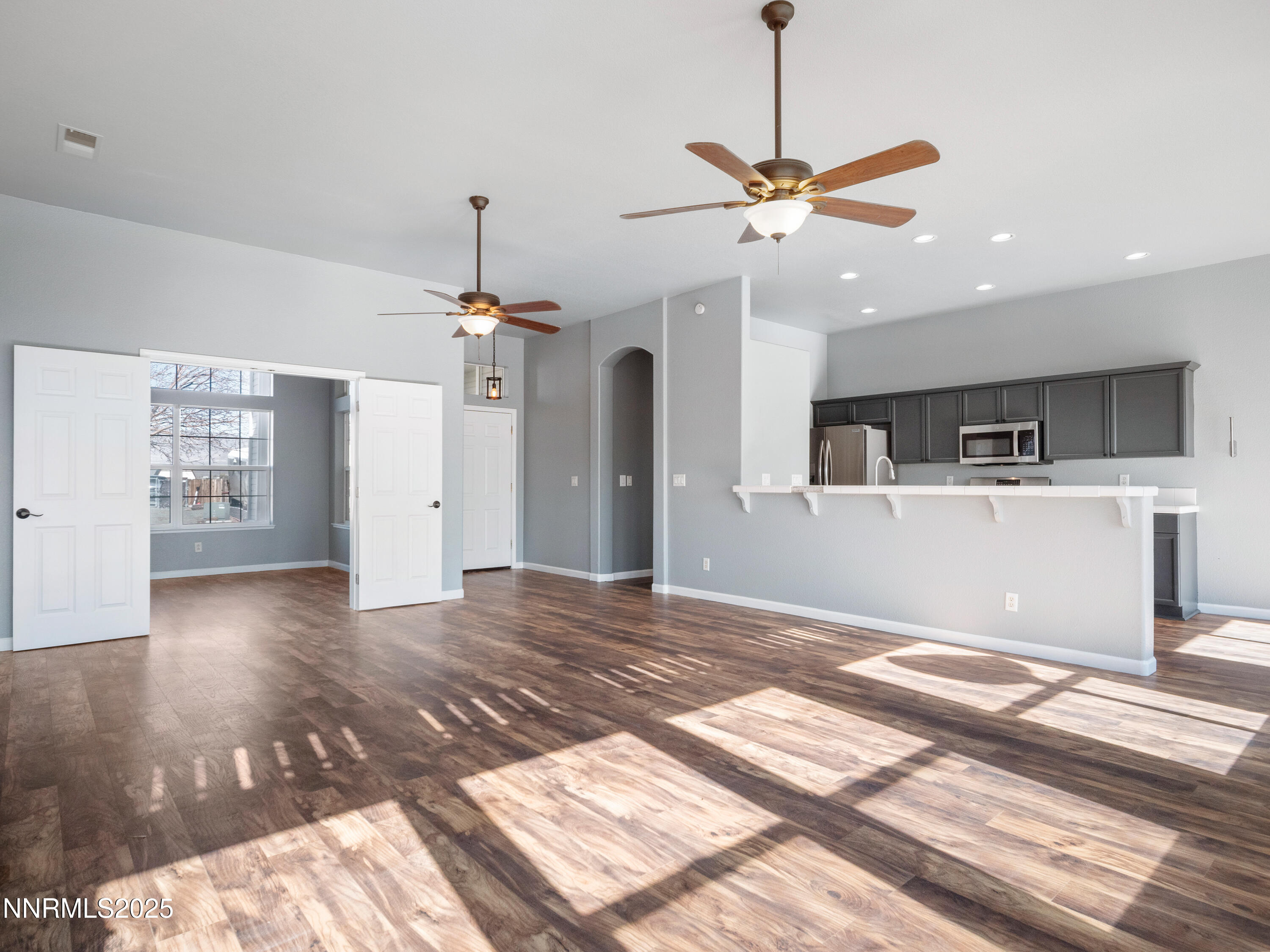 117 Elk Horn Drive Dayton, NV 89403 - Photo 8 of 59 a view of a kitchen with a stove wooden floor and a ceiling fan