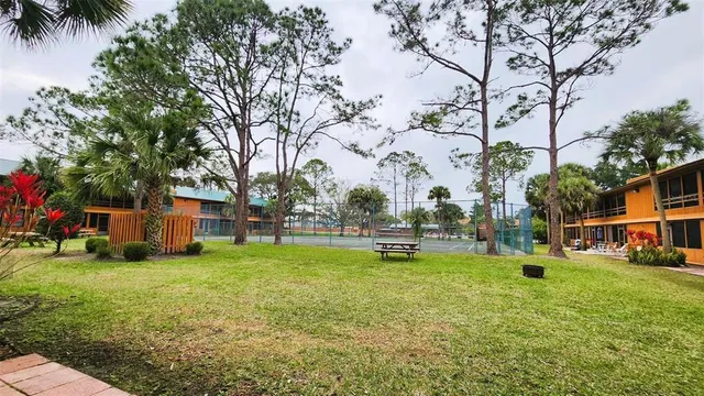 a view of a house with a yard and sitting area