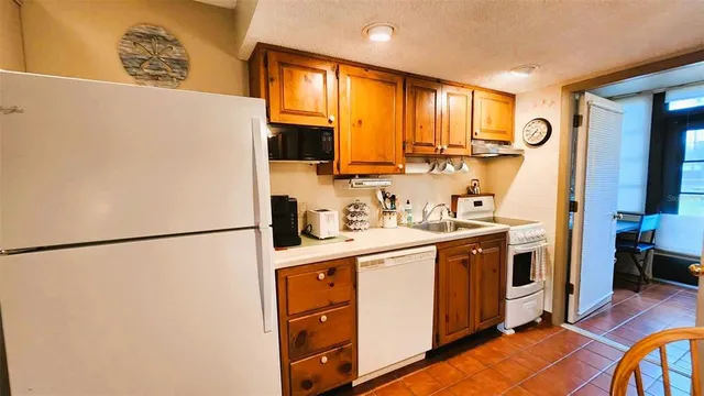 a kitchen with stainless steel appliances a refrigerator sink and cabinets