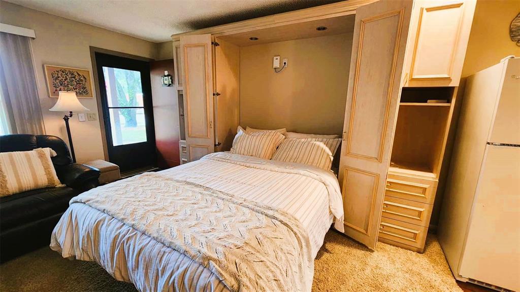 3200 River Ranch Boulevard, Unit 160 River Ranch, FL 33867 - Photo 6 of 20 a bedroom with a bed and a mirror