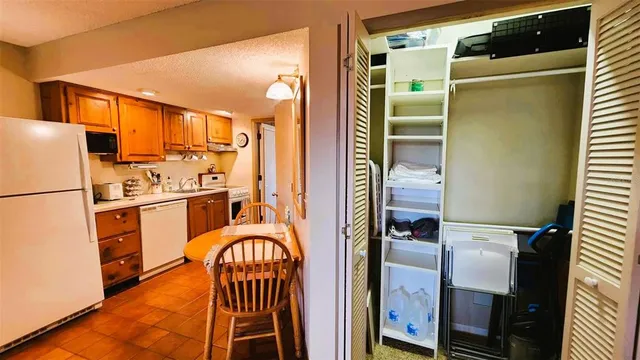 a kitchen with stainless steel appliances a refrigerator and a stove top oven