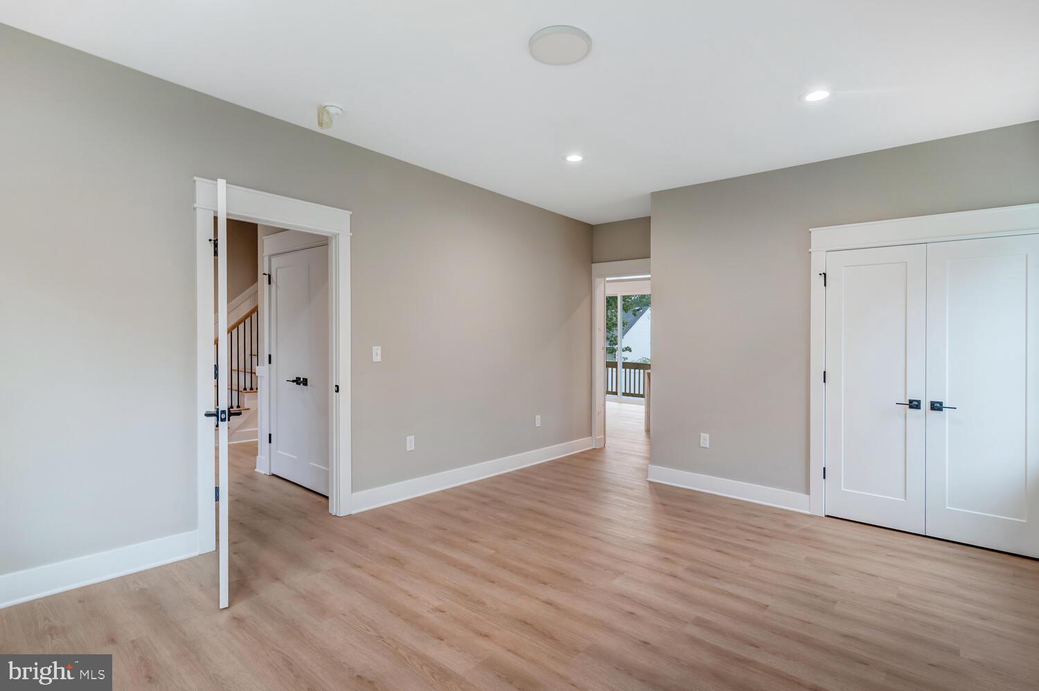 264 Schooner Road Manahawkin, NJ 08050 - Photo 12 of 37 an empty room with wooden floor & windows and bathroom