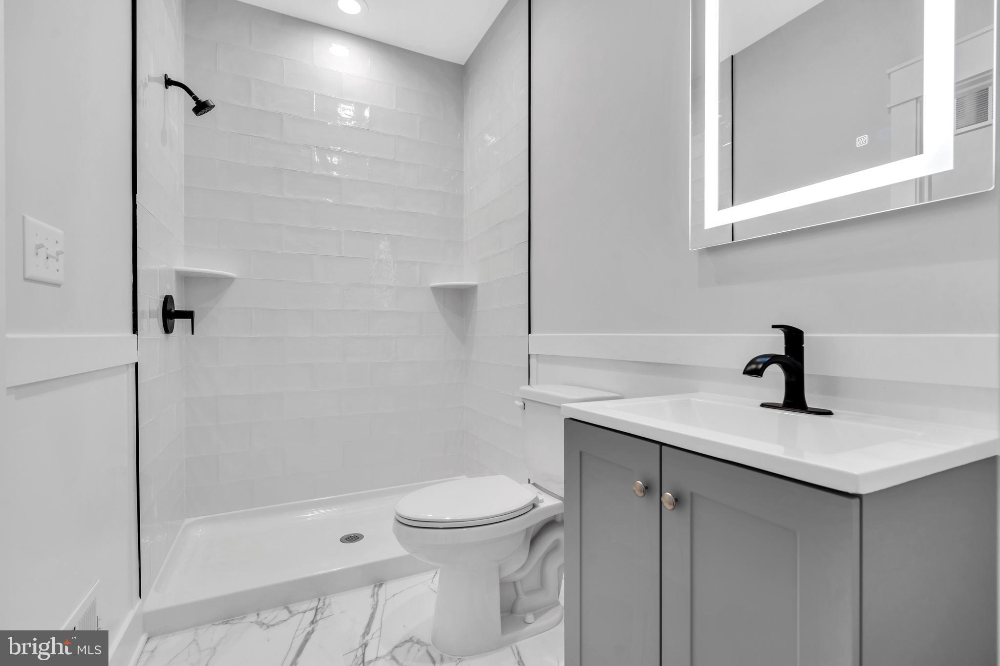 264 Schooner Road Manahawkin, NJ 08050 - Photo 14 of 37 a bathroom with a sink a toilet and shower