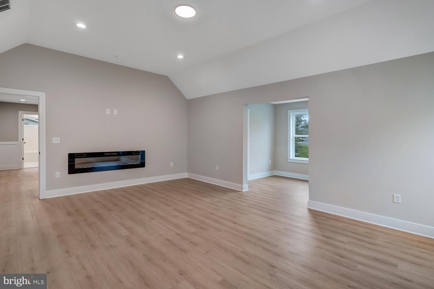 264 Schooner Road Manahawkin, NJ 08050 - Photo 16 of 37 a view of an empty room with wooden floor and a window