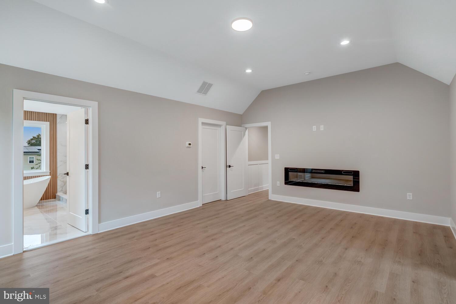 264 Schooner Road Manahawkin, NJ 08050 - Photo 18 of 37 an empty room with wooden floor and windows