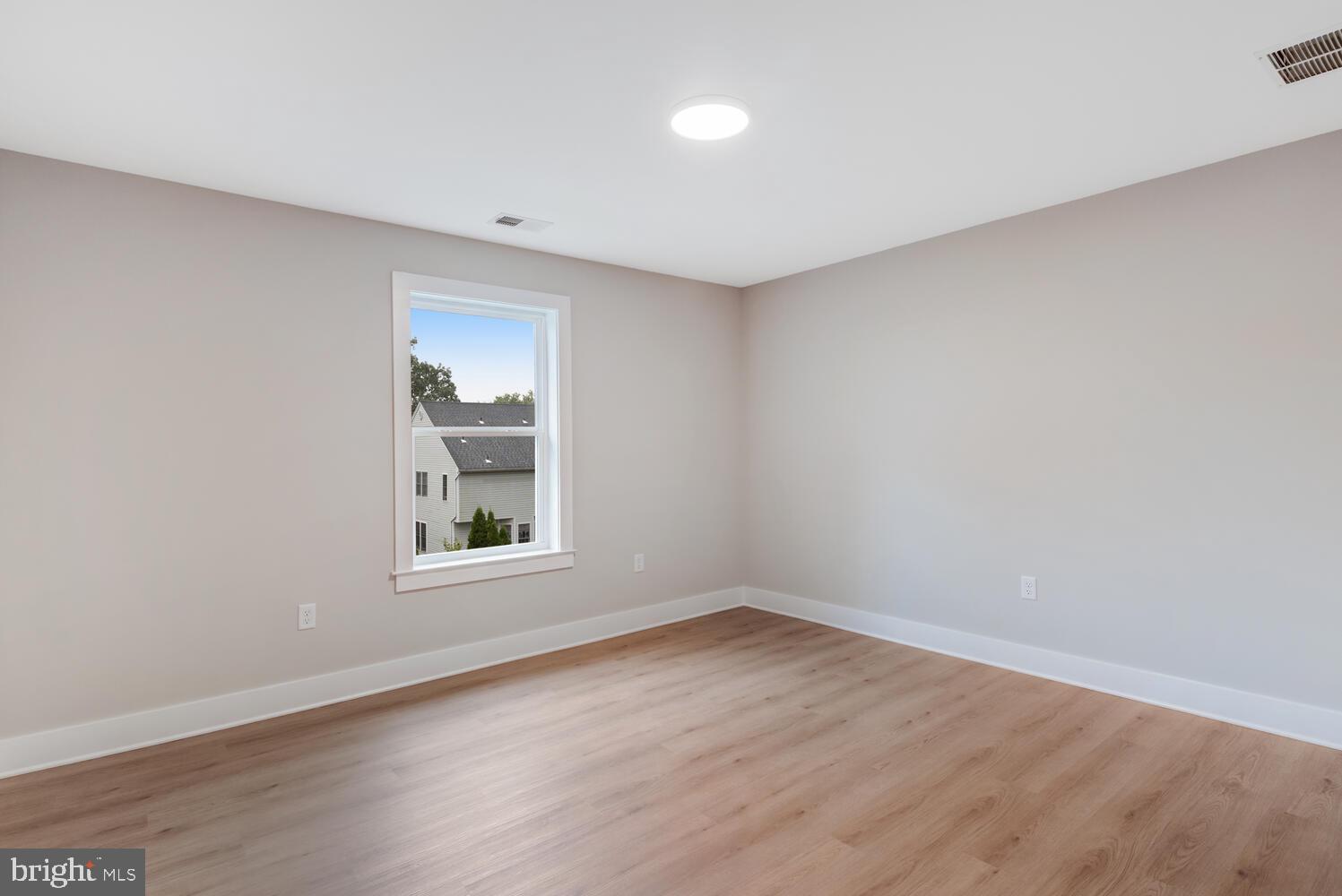 264 Schooner Road Manahawkin, NJ 08050 - Photo 24 of 37 wooden floor in an empty room with a window
